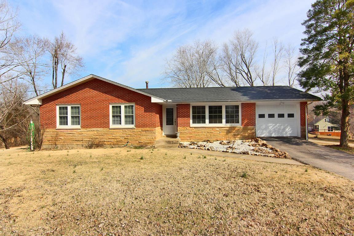 Situated on a .62-acre lot on a quiet country corner just outside Marble Hill City limits this ranch-styled, 1,756 sq ft home is smoke-free with a low maintenance exterior of red brick and stone with white siding on the back wing This house has three bedrooms and 2 full baths, a living room, a nice size kitchen and dining area with a walk out on to a 14 ft X 14 ft deck. It has a dishwasher, sink-disposal unit, and a gas range along with all Oak Cabinets.  Off to its side there is a private den/office area with a separate walk-up entrance which contains one of the 2 full baths. The den also has access to the deck and a side porch.  It features a partially finished, full-sized basement with a walk-up to the outside. The basement contains a small tool-room and storm shelter area currently being used as a food storage room with built in shelving, a finished office area, laundry hook-ups, deep freezer chest and a large unfinished area containing three small windows.