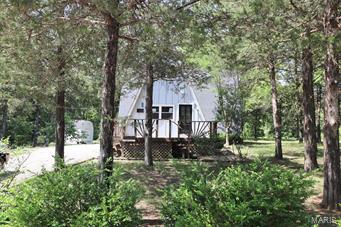 Great opportunity!  Nice home in sought after Terre Du Lac lake and golf course community!  Nice 3 bedroom home is waiting for you!   Big living room with wood flooring; French doors to the rear deck, open kitchen.  Main floor bedroom plus two more bedrooms upstairs.  Big, level, wooded lot for lots of room for outdoor fun.  All this and more in an established lake and golf community.  Enjoy fishing, swimming, boating and much more.  Home would be ideal for year round living or a weekend getaway.  See it today! SpecialListingConditions: Foreclosure