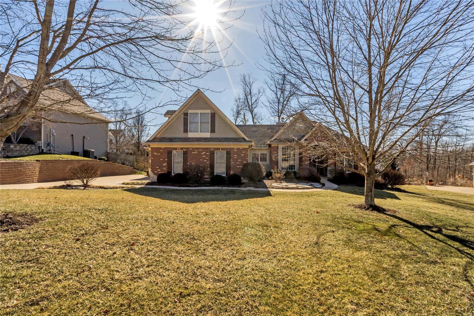 Stunning home in the highly sought after upscale Austin Ridge community. This 5 bdrm, 3 bath home located in a cul-de-sac has an open floor plan & gorgeous hardwood floors. Enjoy entertaining guests in the gourmet kitchen complete w/Viking appl w/double oven & gorgeous granite countertops. Main floor includes 11' ceilings, dining room & a great room w/gas fireplace. Head to the stunning finished lower level and wow guests w/the beautiful wine room, full service wet bar featuring brick & stone capped off w/granite, dishwasher & ice maker! The two-way gas fireplace in the lower level great room can be enjoyed by guests while inside or outside on the covered outdoor patio. Other amenities include a 3 car garage, professional landscaping, whole yard in-ground sprinkler, dual zone HVAC & much more. 2 BRs on main floor, 2 BRs on lower level and another located in the upstairs loft that can be utilized as a bedroom, wrkt room or game room for the kids! Top rated Francis Howell Schools! Additional Rooms: Mud Room