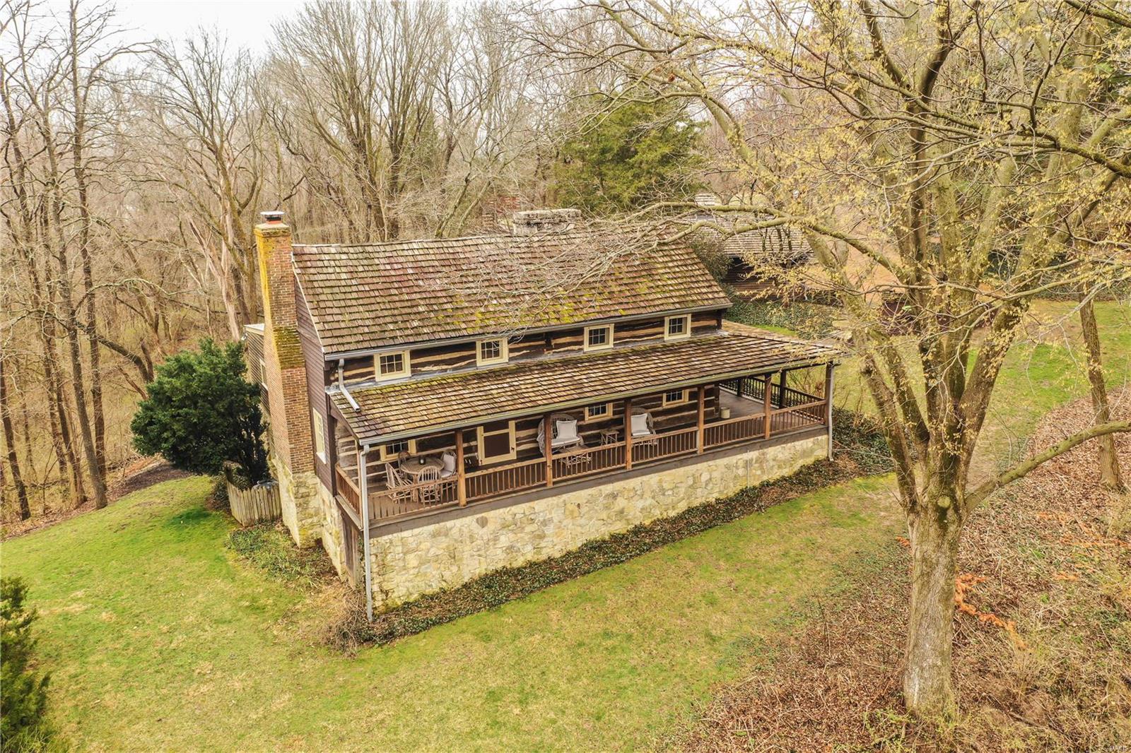 The perfect weekend retreat: Riverwoods! Every minute spent in this 1830 RESTORED LOG CABIN will cover you with joy. Moved from its original location in Hermann stone-by-stone and timber-by-timber then rebuilt exactly so, and placed on a solid concrete foundation. Also included is a cozy apartment below the garage, and TWO ADDITIONAL RESTORED LOG CABINS! Modern amenities combine with real Missouri history, to provide the perfect blend of old world charm and convenience. Sitting on the ridge overlooking the river bend this compound offers amazing views inside and out. The interiors are rustic and most pleasant. Enough sleeping rooms for large families or numerous guest, maybe even ABNB. Imagine special evenings in front of original stone fireplaces or the wrap-around porch or the huge flagstone patio. In three parcels that total about 8 acres stretching from the road to the river manicured lawns, awesome walking paths hundreds of plants and trees with ID tags, and a two car garage. Additional Rooms: Mud Room
