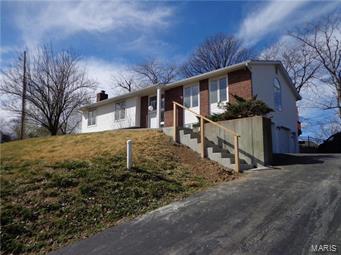 Location, Location, Location!  4 bedroom, 3 bath Raised Ranch, 2 car over sized garage.  Ready to move in.  Total space, 2744, beautiful rec/family room 27x21, FP and wet bar great for entertaining and family get togethers.  Large home with plenty of space. Garage is a tuck under. New sidewalk and steps to front door. Extra Parking on driveway. Yard partially fenced. House sets on 1/2 acre of ground and you will love the grand entry.  A must see!