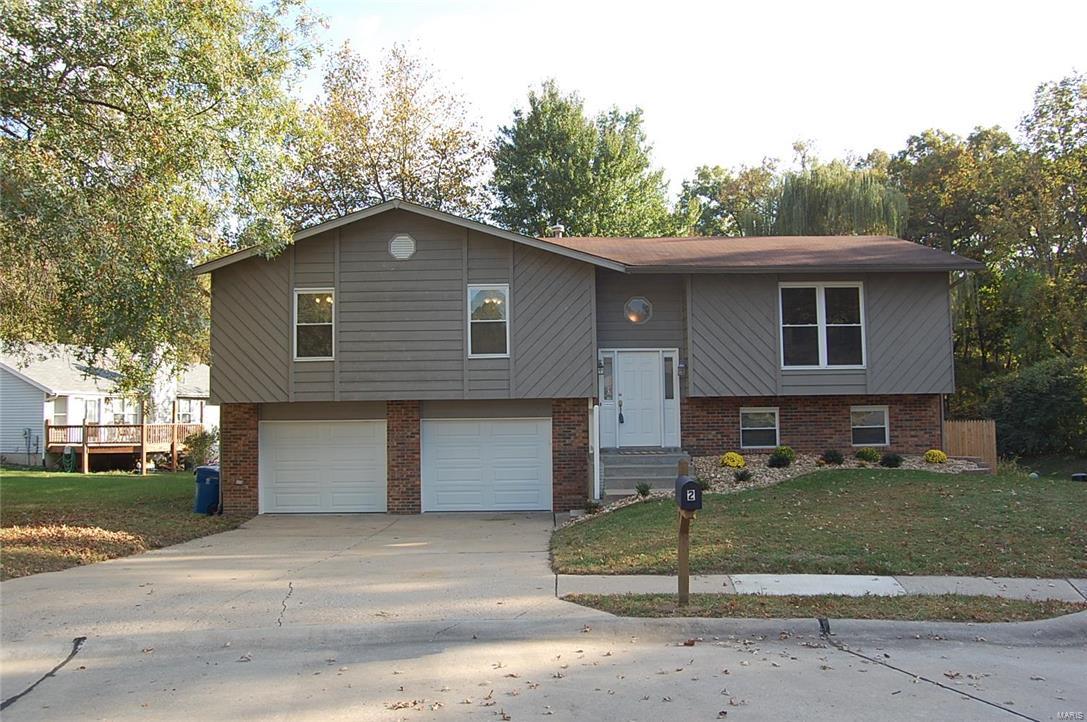 Renovated home in the best location in Saint Charles.  Close to the Page Extension, 70, 270 and 94.  Enter the home and find the open floor plan.  The living room is open and has windows allowing the room to be flooded in the light.  Informal dining area has access to the large deck and beautiful fenced and wooded back yard.  The kitchen has been rehabbed and has new glass tile backsplash, new appliances, updated lighting and new countertops.  The master suite is has its own private bath and ample space with mirrored closets.  The large secondary bedrooms share a spacious bath.  The lower level has a roomy family room with room for a game room, wood burning fireplace and laundry room with storage.  Oversized garage.   Cul de sac lot.  Meticulously maintained.