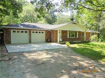 3 Bedroom Brick Home in Park Like Setting with over 2000 SQ Feet just on the Main Level!  Main Level features Family Room, Dinning and Living Room Combo with Wood-Burning Fireplace, Separate Kitchen with Custom Wood Cabinets, Master Bath and Main Floor and Basement Laundry. Basement includes Family Room with Second Wood-Burning Fireplace, Utility Room, Storage Room, another Open Family Room and Kitchen with Refrigerator, Stove, Sink and Wood Cabinets. Forced Air Electric Heating with Wood Furnace Supplement. Over-sized Two Car Garage, Fenced in Back Yard and Fenced in Garden Area! One Year Home Warranty is Included! Schedule your Showing Today!!