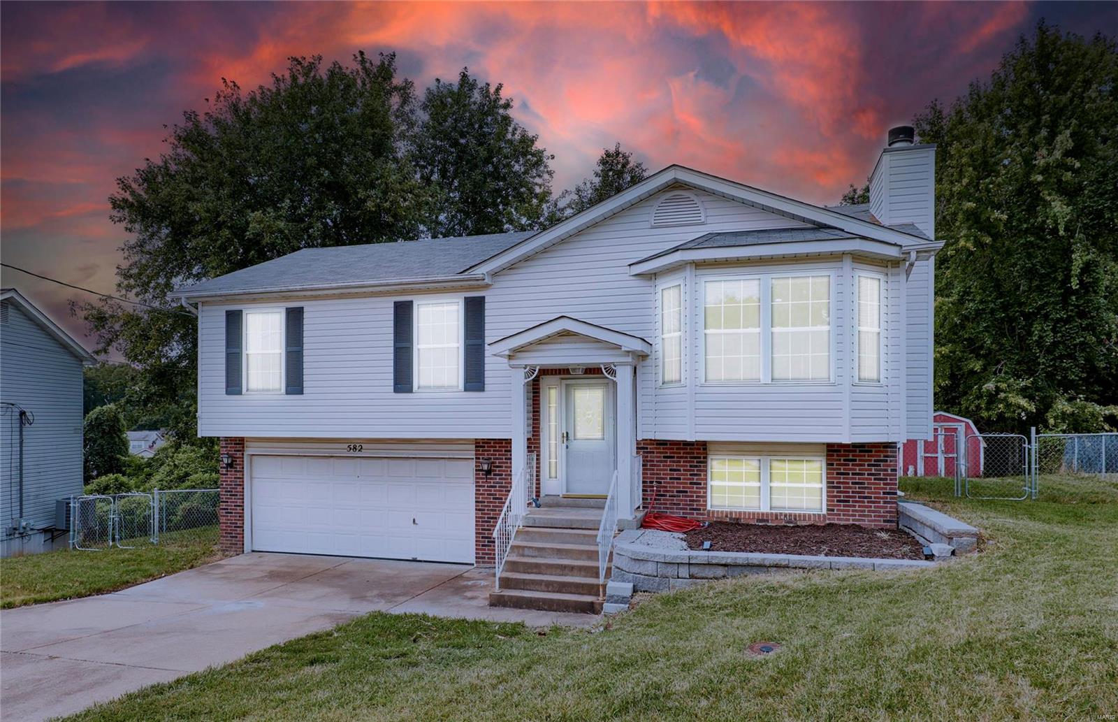 Discover this beautifully updated 4BD/2.5BA split-foyer home, featuring a fresh, modern feel with new paint, flooring & lighting. Enjoy the charm of a cozy bay window seat with hidden storage & a welcoming living room with a classic brick wood-burning fireplace. The chef’s kitchen shines with butcher block counters, farmhouse sink, custom shelving, a stainless steel French-door fridge, DW & smooth-top range. The dining room opens to a sprawling deck with composite flooring, perfect for outdoor entertaining & overlooking a fenced yard & wooded common ground. The main level boasts 3 bdrms & 2 full baths. The primary bedroom adjoins the 2nd bdrm where a closet was removed, though it's easily converted back to a traditional layout. The finished lower level offers a massive bonus room that could be used as a 4th bdrm--plus half bath, laundry & unique storage solutions. A spacious patio complements the oversized 2-car garage. Located in Seckman schools. Some photos are virtually staged.
