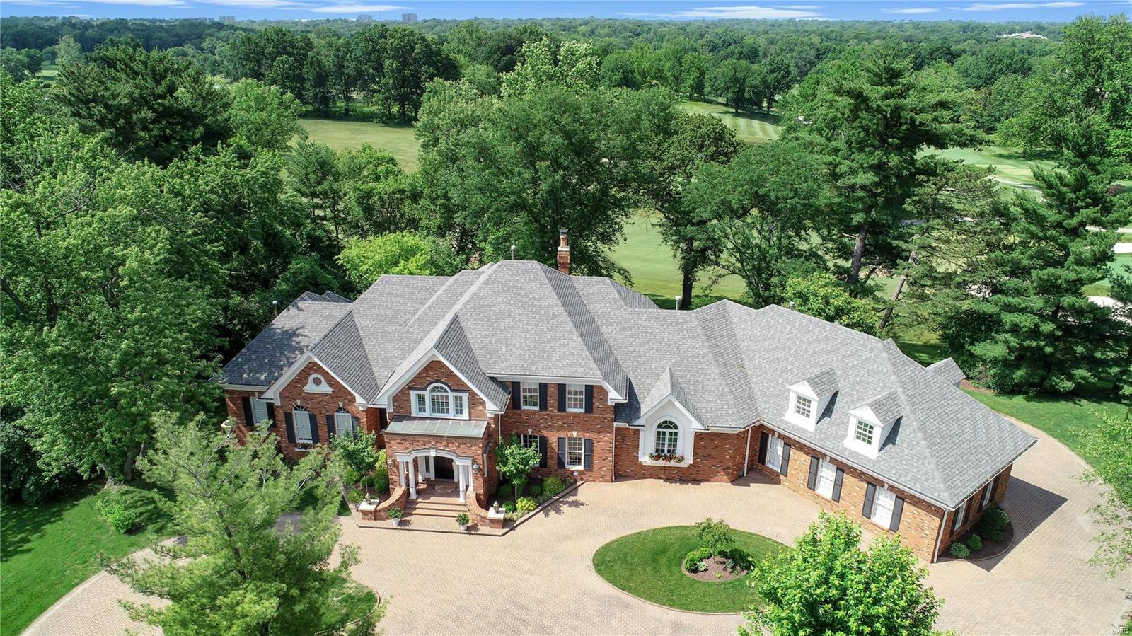 *New Price!* Enjoy spectacular golf course views from almost every room in this beautiful home featuring outstanding recent renovations, stunning neutral decor, floor plan perfect for today's lifestyle, architectural detail, and wood floors! Two story marble foyer with sweeping staircase, step down to dramatic two story great room featuring a wall of palladium windows, limestone accent wall, wet bar, spacious dining room, kitchen with center island, Taj Mahal quartzite counters, stainless appliances, open to breakfast room with coffered ceiling & step down hearth room with fireplace/limestone surround, powder room with granite counter & lava stone sink, master bedroom suite with walk-in closet, sitting room with built-in cabinetry/shelving, spa-like master bath with soaking tub & steam shower, screened porch, laundry room, additional half bath complete the main level. Second level offers 3 bedroom suites + bonus room above garage. Abundant storage in full basement. Patio. 3 Car garage.