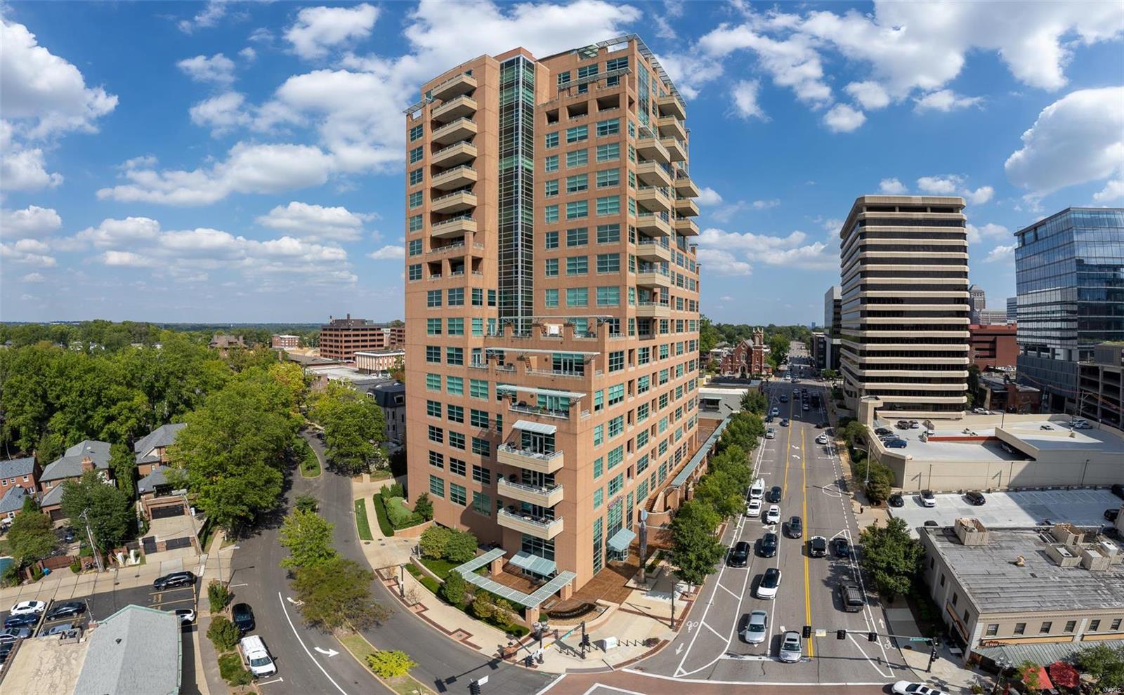 Maryland Walk in the heart of Clayton! This 8th floor, 3 bedroom, 2 full bath corner condominium with South, West and stunning North views is everything that you have been patiently waiting for. Spanning 1,832 square feet this incredible sun-filled home epitomizes luxury living. With volume ceilings, gorgeous hardwood floors, walls of windows, and an open-concept layout, the space strikes the perfect balance between grand and inviting. An entertainer's dream that allows your guests to flow from many open spaces centered around the 2018 remodeled kitchen; Kitchenaid appliances include a gas range, undermount lighting showcasing the stylish backsplash & stunning quartz countertops. Enjoy the south & west facing twinkling lights while you lay in bed in your primary ensuite; remodeled glass shower, custom tile w/ bench. Inviting guest bedroom plus private office. Many luxury amenities; saltwater pool, gym plus the roof top lounge & patio. 2 garage spaces plus storage. Welcome home! Location: Corner Location, End Unit