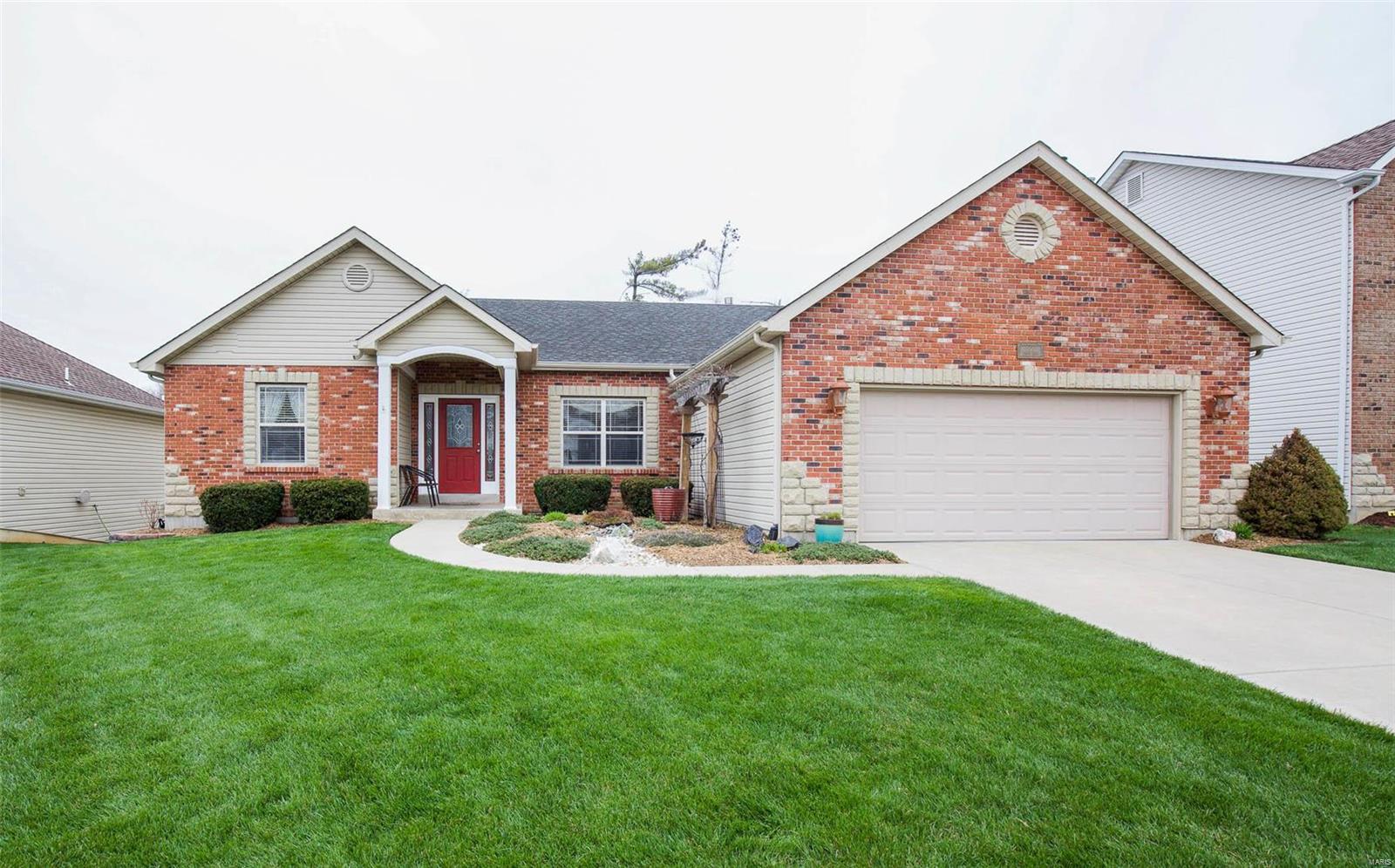 Pull out your checklist; this home has it all. Drink in the beautiful hardwood floors, the openness of the vaulted living area, & the brick surround fireplace. A roomy kitchen adjoins the living room & features a pantry, stainless steel appliances, ceramic tile backsplash and bay sliding door onto the deck. Past the kitchen, is the main floor laundry/mud room conveniently located off the garage. The serene master bedroom complete with walk in closet, private master bath, dual sinks and jetted soaking tub. The additional larger than average main floor bedrooms have upgraded ceiling fans and are completely separate from the master. Downstairs has a walk out, two additional bedrooms and a custom workshop that has ventilation for all your projects. New HVAC, water heater and located right off 364 with easy access to the Katy Trail. From the professionally landscaped fenced yard on the premium lot, to the all the added bonus features, the design details shine through
