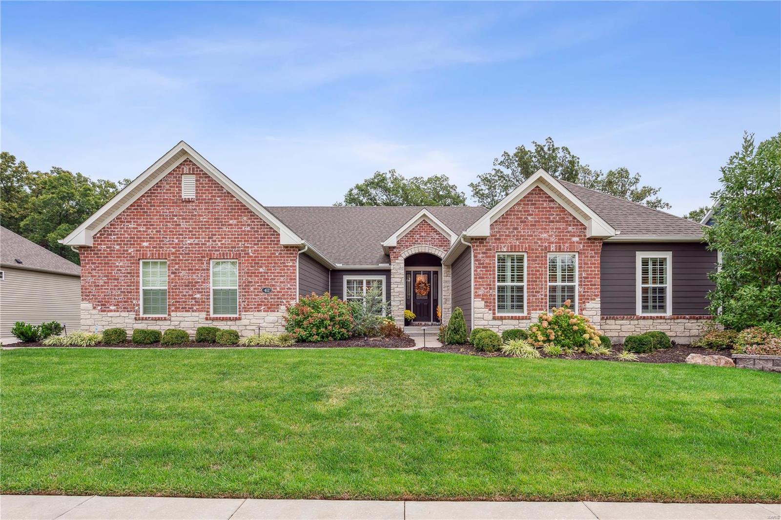 EXCITING OPPORTUNITY TO OWN AN AMAZING 5 YEAR OLD STUNNING 4 BEDROOM,3.5 BATH RANCH SETTING ON OVER 1/2 ACRE WOODED LOT WITH A PRIVATE  BACKYARD OASIS INCLUDING 10,000 GALLON SALT WATER POOL AND OUTDOOR FIREPLACE COMPLEMENTED BY LUSH LANDSCAPING! With current high construction costs & long build times, this beautiful home is ready for your family to just move in & enjoy. Open concept floor plan & wood flooring flows from Foyer all the way thru Great Room, Kitchen & Hearth Room. Great Room highlighted by wall of windows & custom built-in cabinetry. Stone fireplace flanked by bookshelves in Hearth Room. Gorgeous Designer Kitchen open to Great Room & Hearth Room perfect for gatherings/entertaining. Abundant custom cabinetry, granite counters, large island, gas cooktop w/pot filler, tiled backsplash, butler pantry. Finished walkout lower level features Family Room, custom bar, media room, bath & walkout to pool. BEAUTIFULLY APPOINTED HOME & OUTDOOR OASIS WITH POOL READY TO MOVE IN & ENJOY!