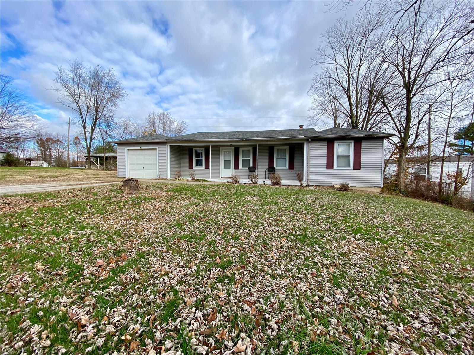 Built in 1967, this ranch style home offers a covered front porch to greet you. Step inside and you’ll be amazed by the generously sized living room. An adjacent breakfast nook attaches to the kitchen where you will find all appliances included. You will enjoy the privacy of a split bedroom floor plan. An enclosed sunroom makes a great space for an office area or for your plants to thrive. This home has a partial basement for storage. There is an attached one car garage with an auto opener and a work bench for the hobbyist. This home is situated on nearly a half acre lot with a convenient location. This would make a great first time home or would be perfect for someone wanting to downsize to one level living.