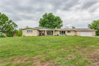 This beautiful brick home sits over a full basement and a two car garage with built in storage. Pulling up, you will notice the large yard and covered front porch- perfect for those early morning cups of coffee. The spacious living room is carpeted for comfort and offers tons of natural lighting and a gorgeous brick fireplace. The kitchen is massive and features an ample amount of cabinetry, gas stove, pantry, center island with a second sink and access to the covered back patio overlooking the large backyard with an above ground pool! The master bedroom provides it's own private master bathroom. There are 2 additional guest bedrooms, an office with a built in desk and another full guest bathroom. The lower level has been framed for three more bedrooms, a large storage area and has a wood-burning fireplace. This home has tons to offer! Call us today to schedule your private showing!