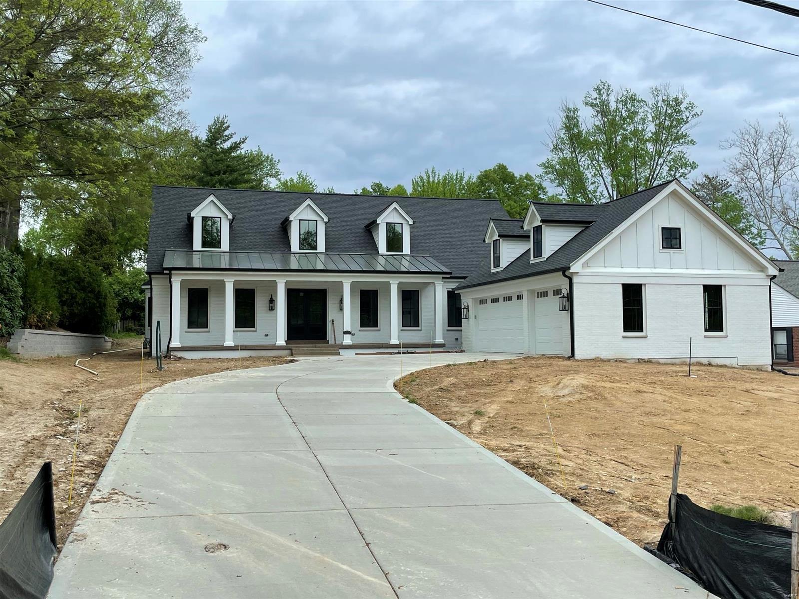 This Modern Farmhouse style custom home to be built in the heart of Ladue School District is conveniently located just 5 minutes from downtown Clayton. An impressive front porch welcomes you to a luxuriously designed home featuring a sprawling, open-concept great rm with a gas fireplace & wet bar, gracious dining room, hardwood floors and 10ft ceilings on the main level.  The kitchen is fully equipped with a state-of-the-art Sub-Zero 48" refrigerator, Wolf double ovens & 48" stove, as well as 2 Bosch dishwashers, microwave oven drawer, custom wood cabinetry and quartz countertops. Plans include a main floor master suite with a spa-like master bath featuring marble floor and shower surround & soaking tub for your enjoyment. 3 additional bedrooms, all with full en suite baths and bonus room are all found on the second floor. Additional features include powder room, 2 laundry rooms, a study, a mud room, an oversized 3 car garage and so much more!