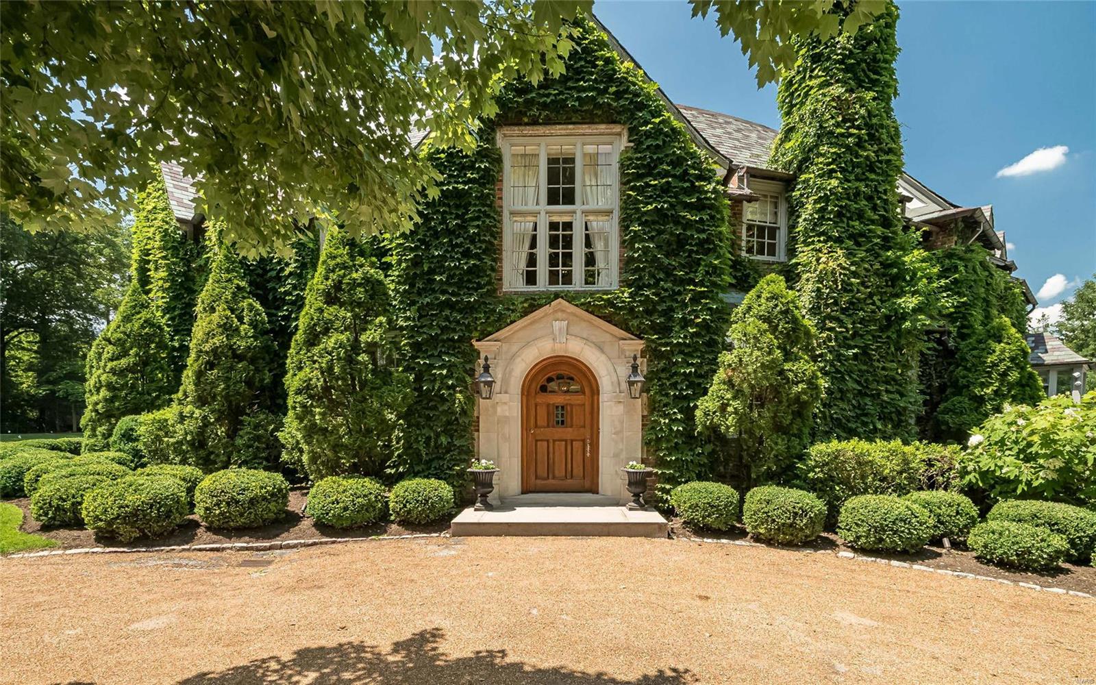 Located in one of the most prestigious lanes in Ladue, this 7500 sq. ft home originally designed by Jamieson & Spearl is perfectly poised on 2.384 acres blending stunning architectural details and updates for today's living. The circular entry hall immediately takes your focus to the light filled glass great room with 12'ceilings in addition to the formal dining room and living room/music room with fireplace and French doors to private terrace with views of the meditation garden and expansive grounds. Charming wood paneled study with built ins & fireplace and an updated kitchen/breakfast room including a large center island and top of the line appliances with easy access to the outside. The elegant staircase with landing gracefully ascends to the second floor where you will find the outstanding master suite with his/her bathrooms/closets and gas fireplace. 3 other bedrooms and two full baths with terrific closets/dressing room. Great 3rd floor and garage w/apt. Partial finished LL