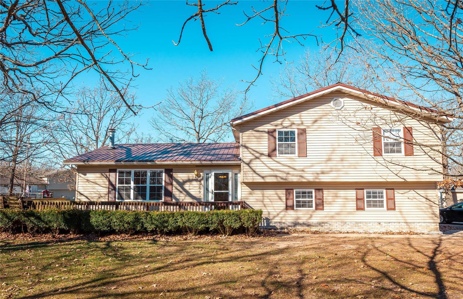 Welcome to your new home! Just listed in beautiful and quiet Plato MO. Sitting on 1 acre m/l, Tri-Level home has a wrap around deck with built in seating, mature landscaping and beautiful shade trees scattered in a spacious lawn with an outbuilding, shop and dog run. Inside the rooms are full of sunlight and a wood burning fireplace in the living room is sure to take the chill off. The dining room and kitchen share a built in oak china hutch, pantry and plenty of cabinets. This home has one bedroom off the kitchen and the other three (including master) are upstairs. Making this a 4 bedroom 2 bath setting. All bedrooms have carpeting and bathrooms have tile. Master bathroom has shower only. The 2 car garage with openers is tucked under and HUGE. It has additional space for hobbies or work area plus a tiled utility room with mop sink on that level. Schedule a showing today this gem won't last long!