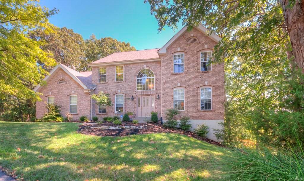Extraordinary home on 1.3 acres. Wonderful wooded lot on a private culdesac. One and a half story, 3384+ sq ft, 4 bedrooms, 2.5 baths. Amenities include professionally finished pickled cabinets and trimwork, hardwood floors, granite counters & backsplash, stainless steel appliances, tile floors in Kitchen and Breakfast Room, double oven, breakfast bar, wall of windows, walk-in pantry, kitchen desk, wine bar, wood burning fireplace with floor to ceiling brick, main floor laundry, built-in folding cabinets, 9ft ceiling on main floor, 9ft pour, walkout lower lever, full brick front, large deck overlooking woods and much more. This home is a must see!