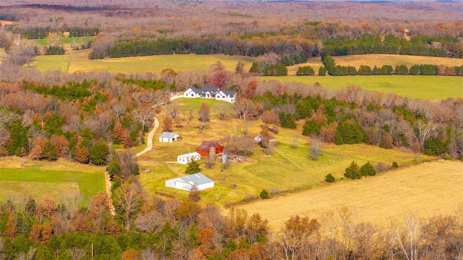 TURN KEY…JUST IN TIME FOR THE HOLIDAYS!!!Embrace yourself for country living at its finest with this modern farmhouse of your Dreams! This stunning home is situated on 51.23 picturesque acres in Rosebud, Mo. From the soaring vaulted ceilings to the impeccable, engineered white Oak hardwood floors, you’ll find no attention to detail was spared and no corner was cut in the fine craftsmanship. Sprawling open floor plan with abundance of natural light throughout the home. Lavish custom kitchen cabinetry, butler’s pantry, quality appliances, are sure to adorn culinary enthusiasts & entertainers alike. Full walkout lower level has been framed, wired and ready for dry wall for additional living space. Primary suite offers a stylish finish & serene atmosphere to retreat to.  If your passion is sunsets and wildlife, there are multiple outdoor spaces to take in the serene views. The barn and out buildings offer an ample amount of storage and space for your livestock & machinery.Welcome Home!!! Additional Rooms: Mud Room