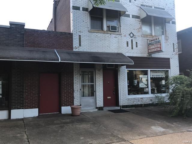 GREAT OPPORTUNITY with a unique SFR property with commercial application on main level. There is also a full basement. This was recently an upholstery shop. Please see past the clutter and see the potential. Nice sized apartment upstairs that offers great space. Own two great properties!
