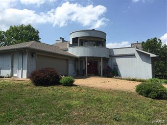 Amazing custom built home. Impressive in every room, Gourmet Kitchen with breakfast area and formal dining room. Family room with Fireplace and attached brick fire Pizza oven. Mexican tile floors large wet bar circular stairways private roof top deck large master bedroom with Master Bath and Separate jetted tub overlooking the 10 acre property. 10 Acres are partly cleared and wooded with abundant wildlife and fencing around the property. Large 60x40 workshop-Garage with 3 oversized doors of which 2 have auto openers. Shop also has water and a full bath. this property is only a couple miles from town but has complete privacy. When you see this house you will feel like you are home.