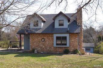 No showings till MONDAY 3-27-2017. Beautiful 1 1/2 story home on 1.5+/- Acre backs up to woods.  This house offers a wood burning stove on main level and a gas fireplace on lower level.  There are 2 large bedrooms on the upper level with walk-in closets and a full bath.  Main floor master bedroom and main floor laundry with additional hookups in the basement. Double hung wood windows, poured patio located off the side of home which connects to the large composite deck off the kitchen that leads to your above ground pool.  Lining and sand in-ground filter replaced 2015. Lower level patio is aggregated.  Septic replaced 2011 and cleaned 2017. More pictures to come Monday 3-27-2017.