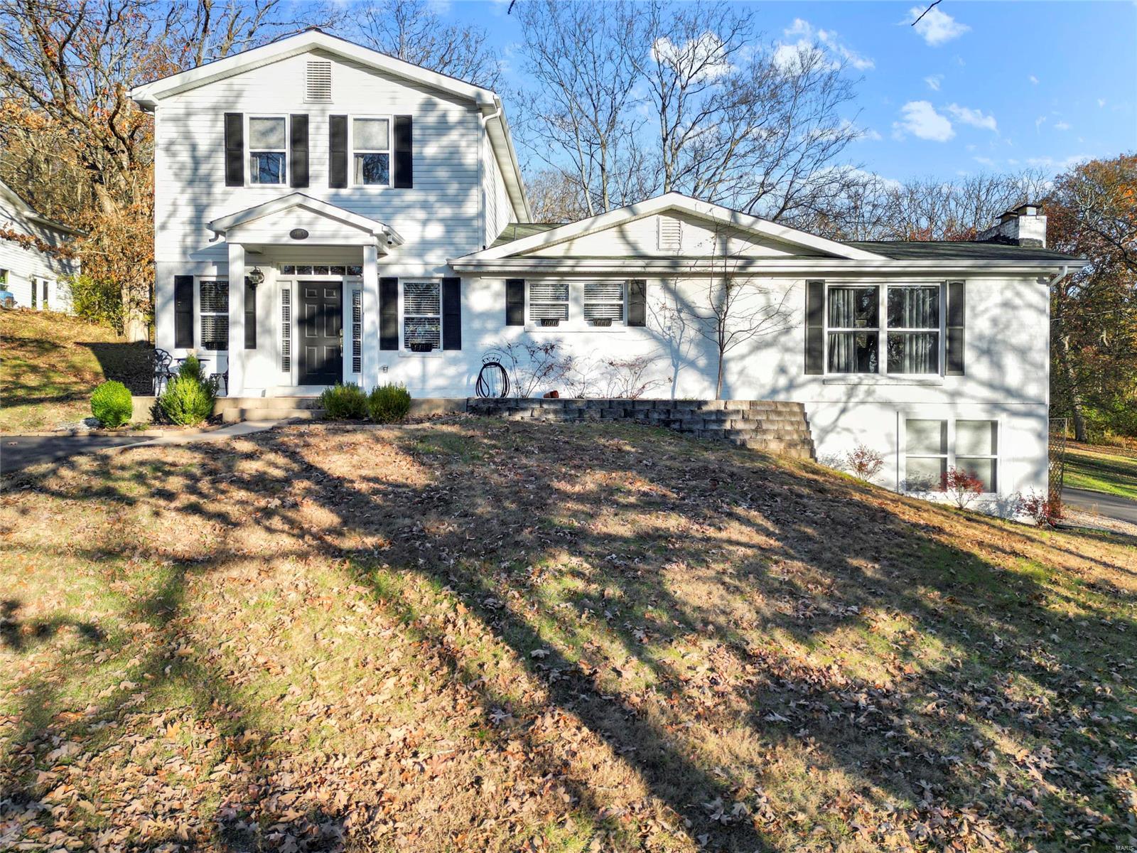 BONUS! Sellers now offering a Home Warranty at closing with purchase! Welcome Home to 2113 Oakview Dr. This stunning home is nestled on 1.25 acres with Approximately 2,500 sq. ft. of living space. This home has so much to offer. Walk into a huge open great room with 9ft. ceilings that has so much room to entertain guests that walks out to a patio to drink your morning coffee on and an amazing view. Gorgeous floors throughout on the main level. Eat-In kitchen with natural cherry wood cabinets. Then flows into the dining room with a brick fireplace that walks out to the deck. Open stairway to the finished family room in lower level that also walks out to a patio and has a tucked garage. This home offers a Luxury bath with double sinks off the master bedroom that is bigger than you can imagine. Six panel doors, crown molding, and more! Two huge driveways that offer plenty of parking and a detached garage with workspace.  Shows Beautifully. You must see the inside and will be glad you did!