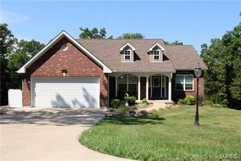 Gorgeous custom ranch home on 3.6 acres!! Better than new! Exquisitely maintained with tons of curb appeal.  The moment you enter the door you will notice the quality and pride of ownership of this wonderful home. You are greeted with gleaming hardwood floors, vaulted ceilings in the living area, formal dining room with tray ceiling.  Arched opening and doorways to the eat-in kitchen with custom cabinetry, granite counter tops and ceramic tile flooring with black appliances ( all appliances stay!), maintenance free covered deck area overlooks the beautifully landscaped back yard backing to trees.  Home features 3 bedrooms, 2 full baths, a large and conveniently located main floor laundry room with sink. Master bath with soaking tub, double vanities and separate shower, huge walk-in closet!  The walk out- basement is perfect for your finishing touches and leads out to a patio (pool table in basement stays!).  There is also a 20x20 two-story outbuilding with a loft! This is a MUST -SEE!!