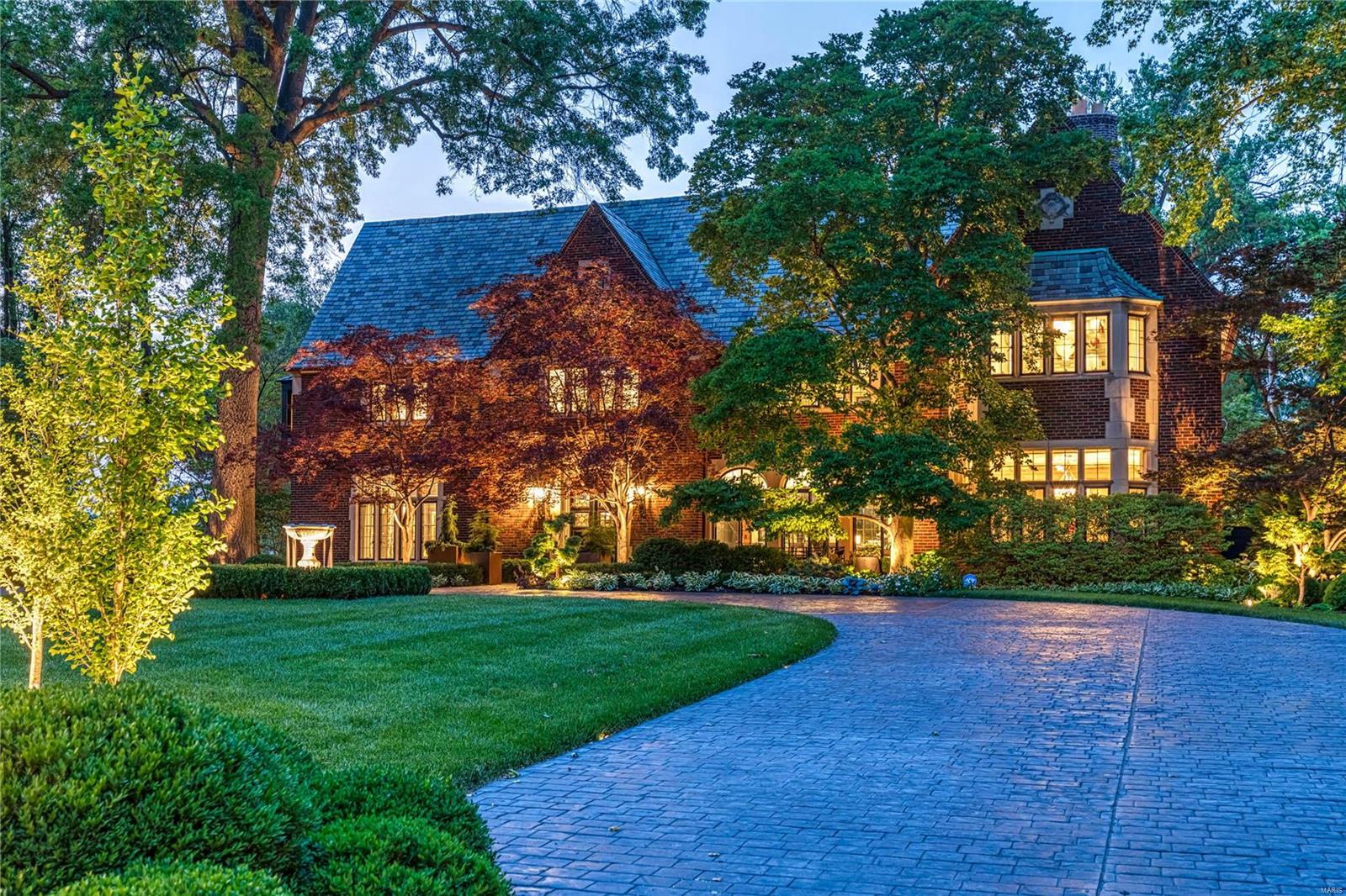 Experience unparalleled luxury in this 1926 Tudor Revival, the first masterpiece by Maritz & Young on Lindell Blvd. Situated on historic grounds, once home to the 1904 World’s Fair Japanese Garden Exhibit, one of the country's oldest and largest Gingko Tree. Enter the grand foyer to find a sweeping circular staircase adorned with a cascading "John-Richards-Japanese Wisteria" chandelier. The loggia, a true jewel, features radiant slate flooring and floor-to-ceiling arched windows overlooking Forest Park and meticulously recreated Japanese gardens. Maritz & Young’s hallmark symmetry shines with mirrored three-arched openings throughout the first floor. The sunken living room, with its beautiful fireplace and restored wax and plaster ceiling, offers an inviting retreat. The enchanting garden features authentic Japanese lighted lanterns, a Wheel of Compassion, a Pagoda-designed pool house, and a stunning lighted pool with Magic Bowl water features. This home is a reimagined work of art.