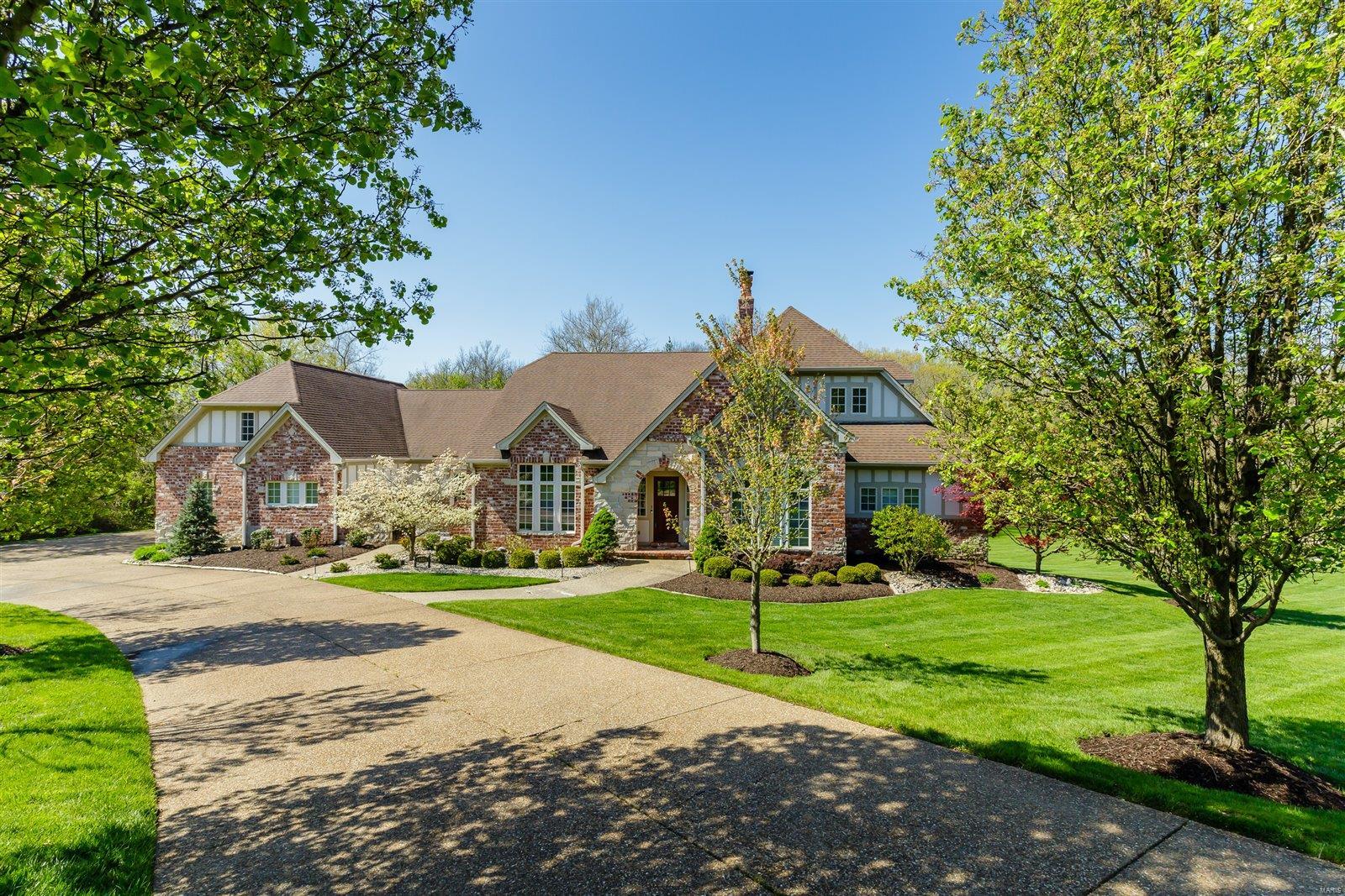 Stunning and beautiful custom Ranch on 1.37 acre lot. Perfect for a pool. This exceptional home has everything a family is desirous of, with 5 bedrooms, 4 full bathroom, a wall of windows with remote controlled electric custom blinds, 4 fireplaces, 3 car oversize garage, a designer chef's kitchen with premium appliances, and a custom Induction cooktop. Full walk behind wet bar. wine cellar, a sunroom, and a wonderful home inside and outside for entertaining. This custom kitchen with granite counter tops, premium appliances, custom cabinets, walk in pantry joins the hearth and breakfast room. Magnificent open floor plan, with stunning great room with full height brick and stone fireplace, built-ins and stunning views. Master bedroom suite adjoins a separate sitting room, luxury master bath with whirlpool tub and separate shower. Extra room in lower level could be used for an exercise room or office, is plumbed in for a theatre. Main floor laundry room. Bring your buyers, today Additional Rooms: Sun Room, Wine Cellar
