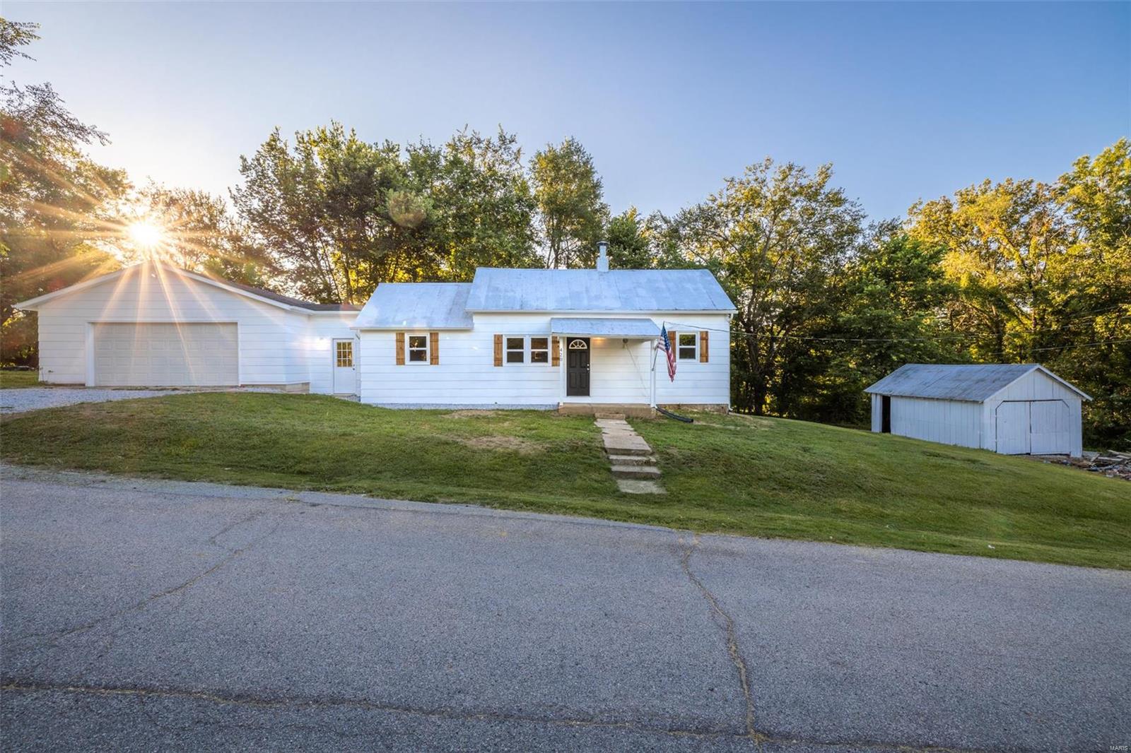 UPDATE - Multiple offers in hand - WILL BE REVIEWED Monday 8/24/20 at 2pm. Low cost of living in a great location, TWO garages, plenty of room for the toys and the tools! Look at the huge oversized 24 x 30 garage attached by a breezeway to this 2 Bedroom Ranch home. Fully updated and move in ready! Updates include: New Flooring, New Appliances, New Kitchen Cabinets, All New Windows and New High Efficiency Air Conditioner. 
House has Metal Roof that has been recently recoated, Garage has Shingle Roof. Main floor laundry with an area for a stackable unit in the kitchen. Lots of charm and room. Propane Furnace & Dryer, Electric Stove, A/C & Water Heater. This is a USDA financing area and is also eligible for FHA. Square footage in tax records is 1792, but house is closer to 920