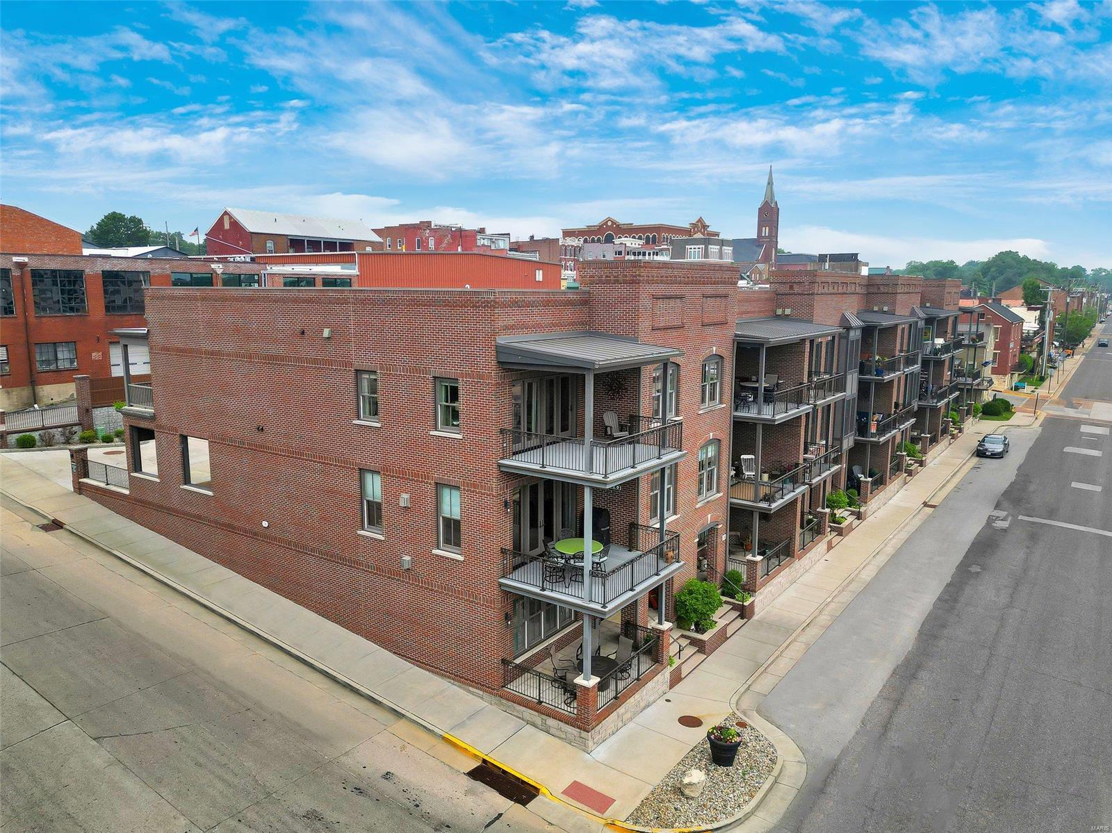 PRICE IMPROVED FOR YOUR DREAM. EXCEPTIONALLY WELL BUILT, ENERGY-EFFICIENT LUXURY HOME w/ MO RIVER VIEWs! An IMPRESSIVE grandeur façade w/ the perfect mix of brick, stone, aggregate, elegant windows, doors, grand white columns & beautifully maintained outside spaces on every level. This lovely townhome w/ 3 full finished floors has a walk-out LL w/ a full bath, family/rec area, Gas FP & more. The main floor boasts a customized kitchen w/ stylish cabinetry, 2 tone island cabs w/ granite tops, stainless apps, a walk-in pantry, & huge brkfst bar all open to the Dining & Great rm w/ FP. Most notable, 10' ceilings, extra thick inner wall & sound batting, custom moldings, solid flrs, wrought iron rail systems, ELEVATOR, 4 covered decks w/ spectacular views, VERY LG MASTER w/ ensuite office, full bth w/ onyx shower, frosted glass drs, lg dbl onyx top vanity, walk-in closet w/organizers, oversized single garage, carport & add'l offstreet parking in private street. Don't miss this VIEW-Call Now!