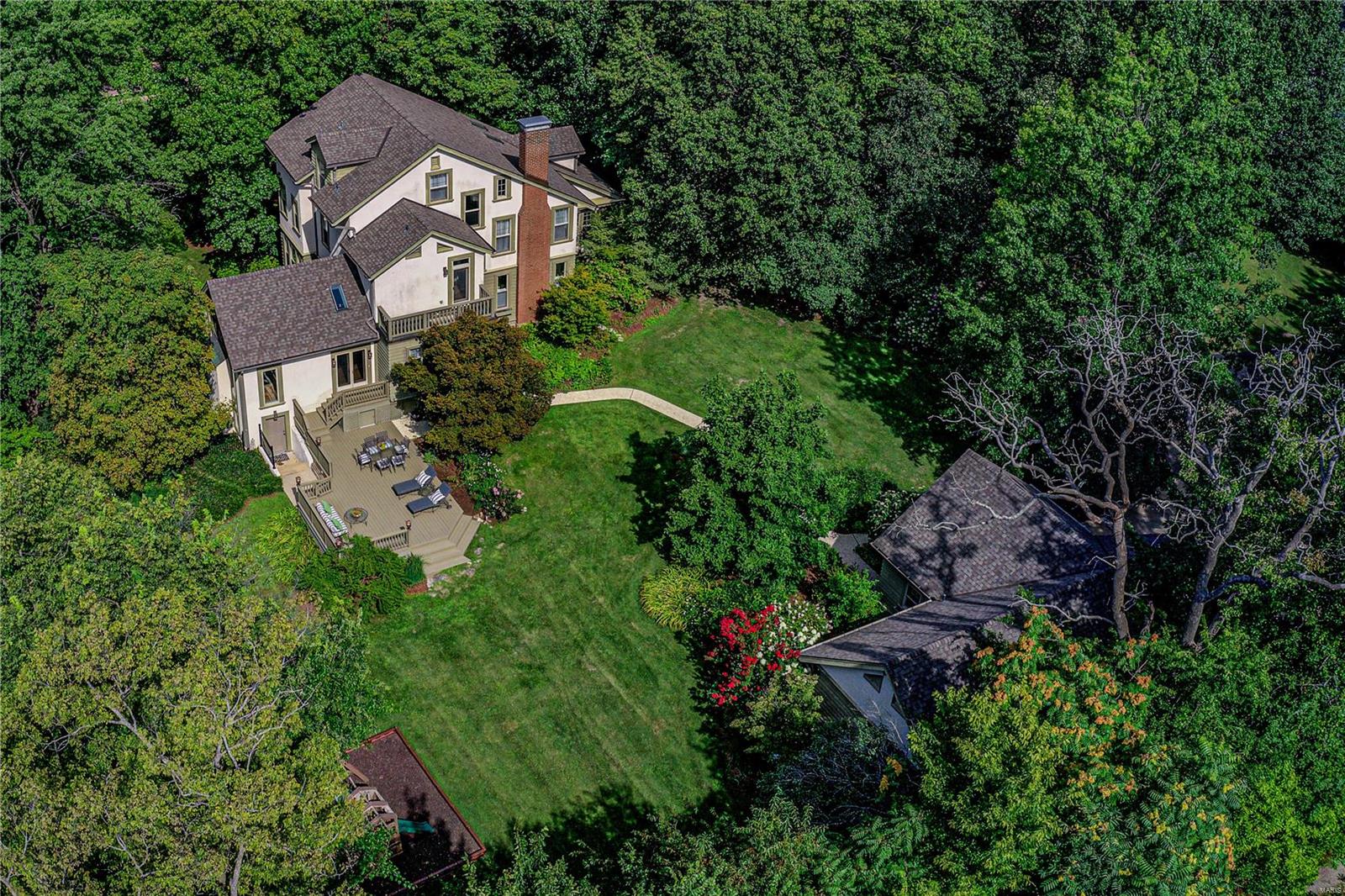 This exquisite Tudor artfully unites classic features and architectural details in this luxurious renovated residence on nearly one acre with sweeping lawns and professional landscaping under a canopy of trees. The chef's kitchen featuring Wolf, Sub-Zero and Asko appliances opens up to the hearth room w/vaulted ceilings and stone fireplace. The Butler's pantry leads to the elegant dining room which flows gracefully into the living room and to the light filled sunroom. The 2nd floor features the master suite complete with spa like bath w/steam shower and claw foot tub as well as an attached sitting room w/ custom closet, laundry closet and access to private balcony. Additionally, on 2nd floor, you'll find the family room, full bath and 2nd bdrm. The 3rd floor boasts two additional bdrms, Jack & Jill bath and a playroom/office. Magnificent lower level with entertaining kitchen, media room, full bath, hobby room w/laundry and bonus room. Serene grounds, 4 car garage, such a special home. Additional Rooms: Sun Room