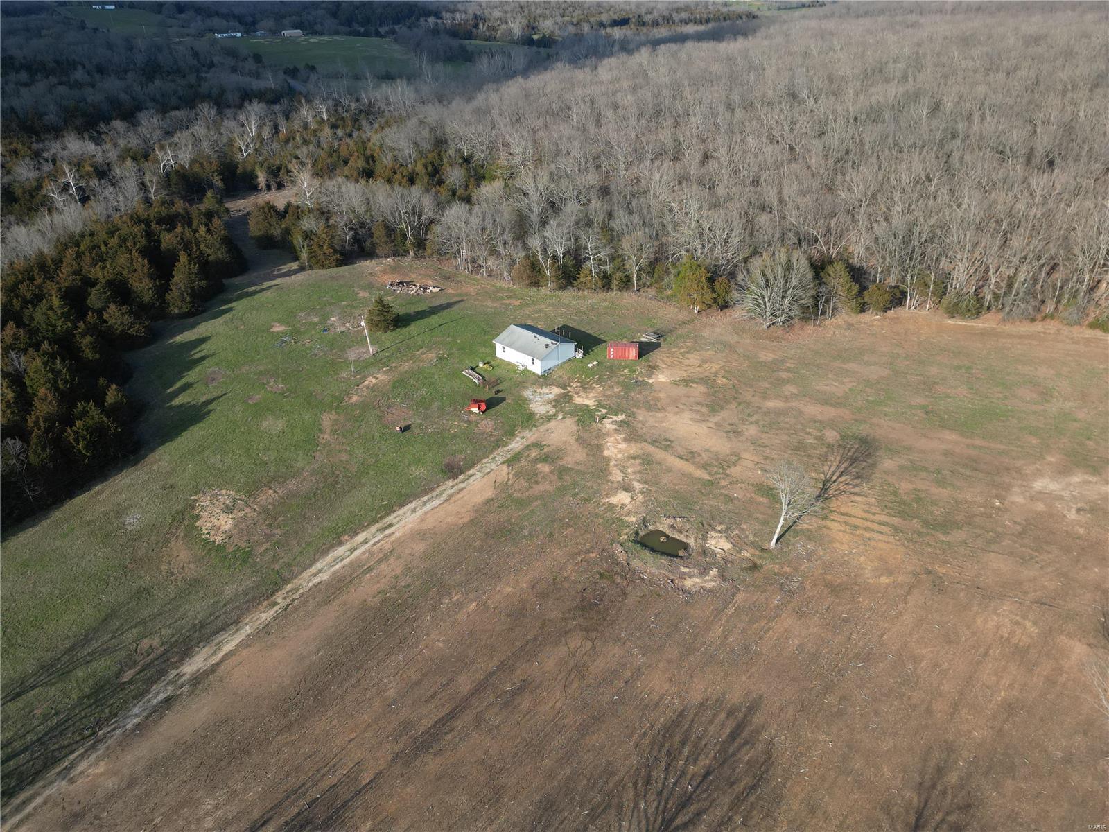 BACK ON THE MARKET, NO FAULT OF SELLER. Tons of Potential! This beautiful property includes 114.5 +/- acres at the corner of U Hwy and KK highway. Roughly 5%  is fenced. Additionally there is pasture land, and the rest of the land is mostly wooded. Sale includes a 3 bed 2 bath fixer- upper house House to be sold as-is. This property will not last!