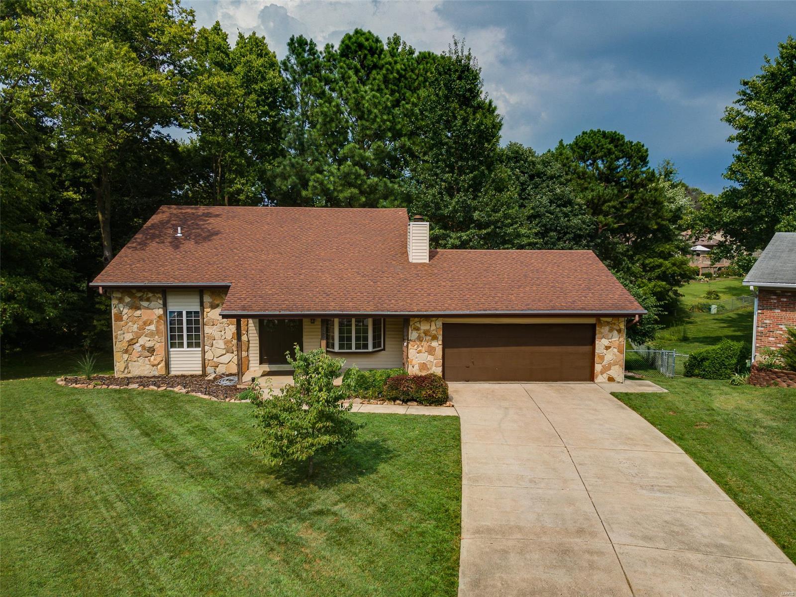 This stunning 1.5 STY home has features that will wow you! Welcome 14 Castlewood Court in the highly sought-after Oak Creek Hills Subdivision.  Impressive double front door entry leads to an inviting living room with a large stone-faced, wood fire place. With ample storage, double oven, electric range and natural light, the newly renovated kitchen is an entertainer’s dream. The kitchen leads to a large deck, and permanent firepit surrounded by new landscaping in the fenced in, shaded backyard. Two large bedrooms on the first floor, primary bedroom on second floor. Second floor features open bonus room–perfect for a cozy space. Home features updated lighting, maintenance-free faux wood laminate flooring, and thoughtful updates throughout.