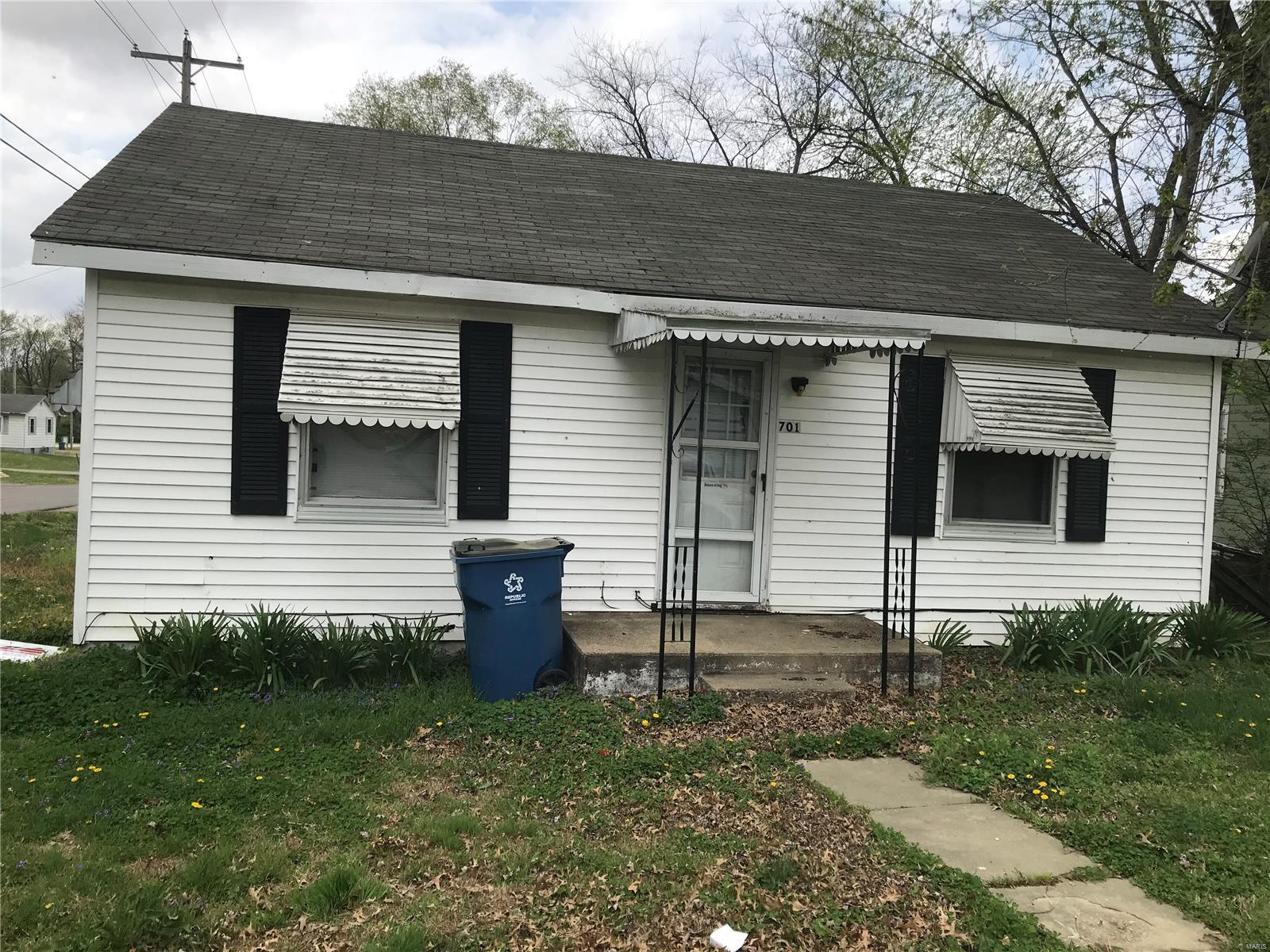 New roof installed.  New siding for home lying in living room floor.  New windows for home lying in living room floor.