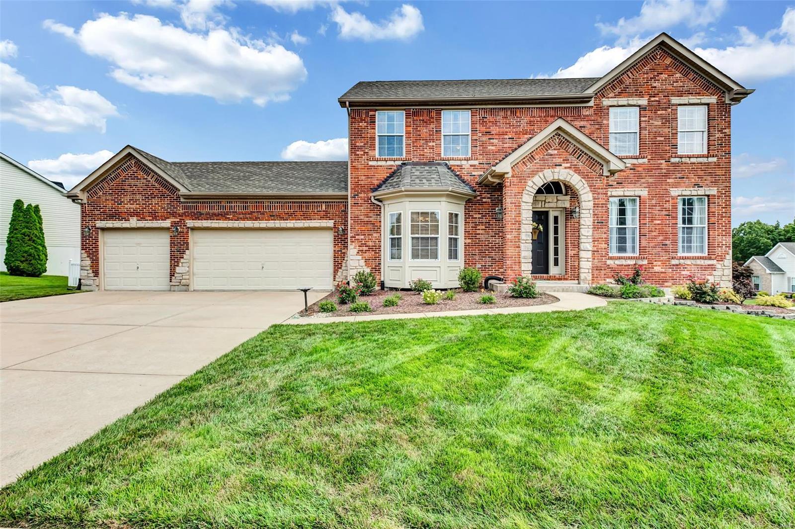 Beautiful two story loaded with upgrades.   Inside you'll find quality extras  9' first floor ceilings, & extensive custom millwork. Impressive 2 story entry w/arched doorways. Formal dining w/sculptured ceiling, crown molding & bay window. Fantastic kitchen features 42" inch Maple cabinetry w/crown, stainless appliances & beakfast room bay. Large family room w/5-window bay & direct-vent fireplace flanked by custom built-in bookcases. Luxurious vaulted master suite w/plant shelves, cultured marble soaking tub & shower walls. Walk-out finished  lower level with full bath, bedroom, game room , wet bar and media /rec room.. Over 1/4 acre lot Fenced yard with a covered 19x13 patio and professional landscaping front & back. Many more features included.