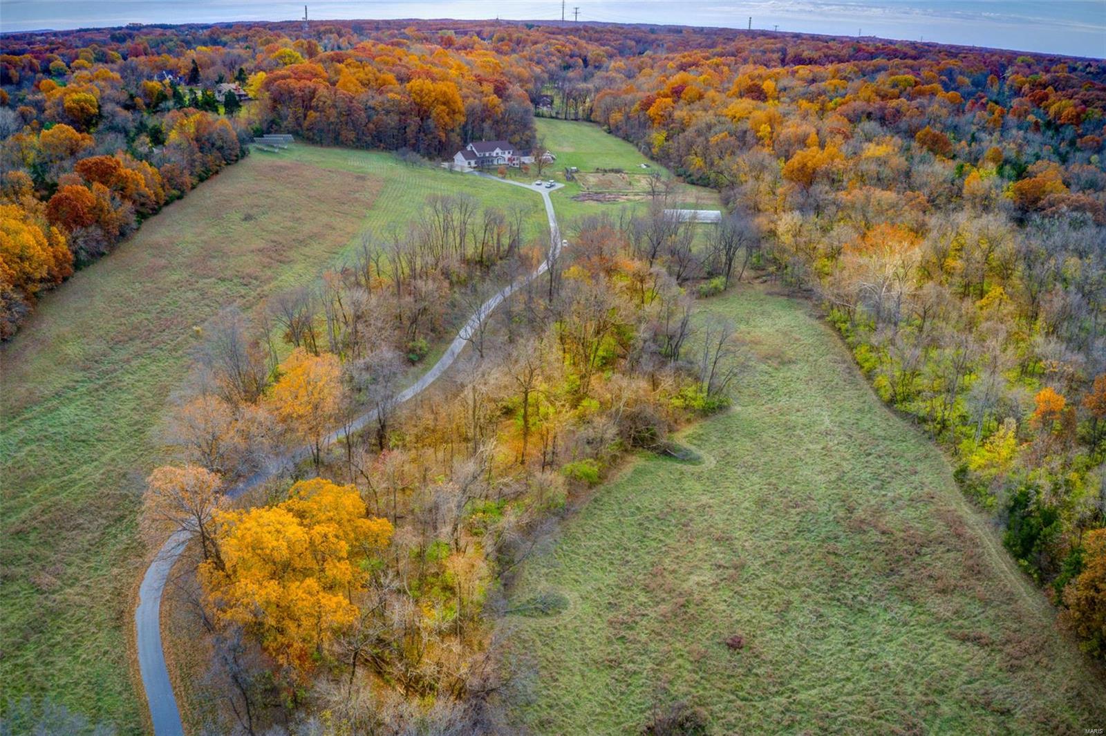 Enjoy ur own private piece of paradise in Wildwood! 36.979+/-acres rolling hills & flat pastureland w/7 bdrm, 6½ baths, 3-car attached & 2-car detached garage. Tranquil drive along the tree-lined driveway to the classic, spacious 5,200+/- sqft, 2stry home nestled at the top of a hill which has been loved & maintained by 1family. Recently refinished gleaming hardwd flrs thru-out most of home. ML boasts a fam rm w/a brick surround FP &built-ins, dining rm, eat-in kitchen, 1/2 bath, screened-in porch & mother-in-law wing:2 bedrms, each w/en-suite bath, &1 w/W/D hookups, its own separate kitchen, &office. UL you will find 5 generous bdrms all w/wd flrs. MS w/HUGE WI closet & bath w/dble sinks .4 add'l bdrms share hall bath. Sleeping area w/ensuite bath & laundry complete UL. Attic area potential for add'l living space. Unfinished, WOLL w/full bath.New stone coated steel roof w/venting system 2020. Energy efficient &eco friendly solar panels.ADA ramps @front door &screened-in porch door. Additional Rooms: Mud Room
