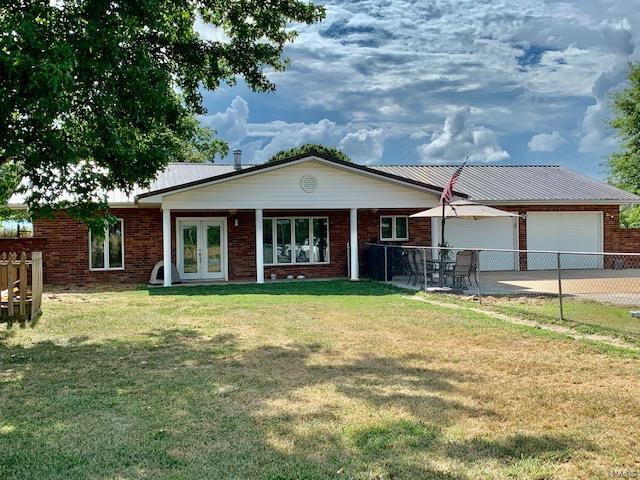 Striking brick home on an acre is surrounded by farm land, and no close neighbors...even though it's in ''city limits'' and has city utilities. 3 BR, 2 bath home has lovely kitchen with lots of bells and whistles: Swing-out pantry, pull out shelves, + many other extras. Open floor plan keeps the family together;chain-link fenced front and back yards. Ground-source heat pump keeps utilities reasonable: all electric home has an avg utility bill of $150. This well-maintained home won't last long at $139,900!