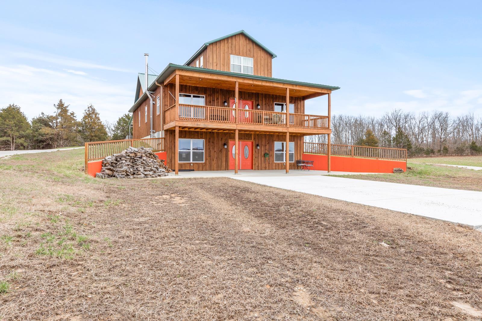 Country living at its best! This stately 5Br/3 full bath 4224 sq ft. home sits on 82.88 acres and is tucked away off of the main road. 
Enjoy absolute privacy while still within minutes to restaurants, shopping, & other amenities. Property is completely fenced with two cattle gates, ready for livestock for your own little mini-farm, kennel, Air BNB, off-grid living, sharecropping--the possibilities are endless as there are no known restrictions. Enjoy the breathtaking views all year long from your 10x36 balcony that overlooks the 3-acre stocked pond. The main level has two spacious bedrooms, 1 full bath, & main floor laundry. The kitchen/dining/living room combo make this house perfect for entertaining. The walls are flanked with knotty pine tongue & groove panels throughout giving this house its rustic charm. Upstairs are two additional oversized bedrooms & a full bath. Downstairs can be its own apartment with 1BR/1BA, a kitchen, laundry room, & a living room with wood burning stove