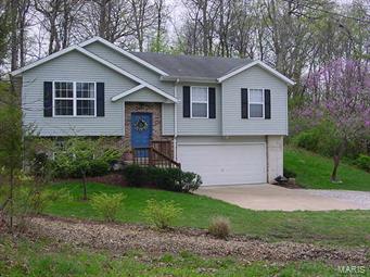 Move in Ready!  Home sits on .95 acre just outside the Arnold City Limits on a private street with no subdivision dues or restrictions. The entire home has been freshly painted in neutral colors ( even the garage ) and is tastefully decorated. There is an open floor plan, patterned hardwood floors, new vinyl windows, 42 inch oak kitchen cabinets. 2 large bedrooms on main level. The lower level has as a 3rd bedroom, featuring a large walk-in closet and full bathroom or can be used as a family room and office space. Sliders from the dining area, a patio and a large private yard backing to woods. Home is a must see!