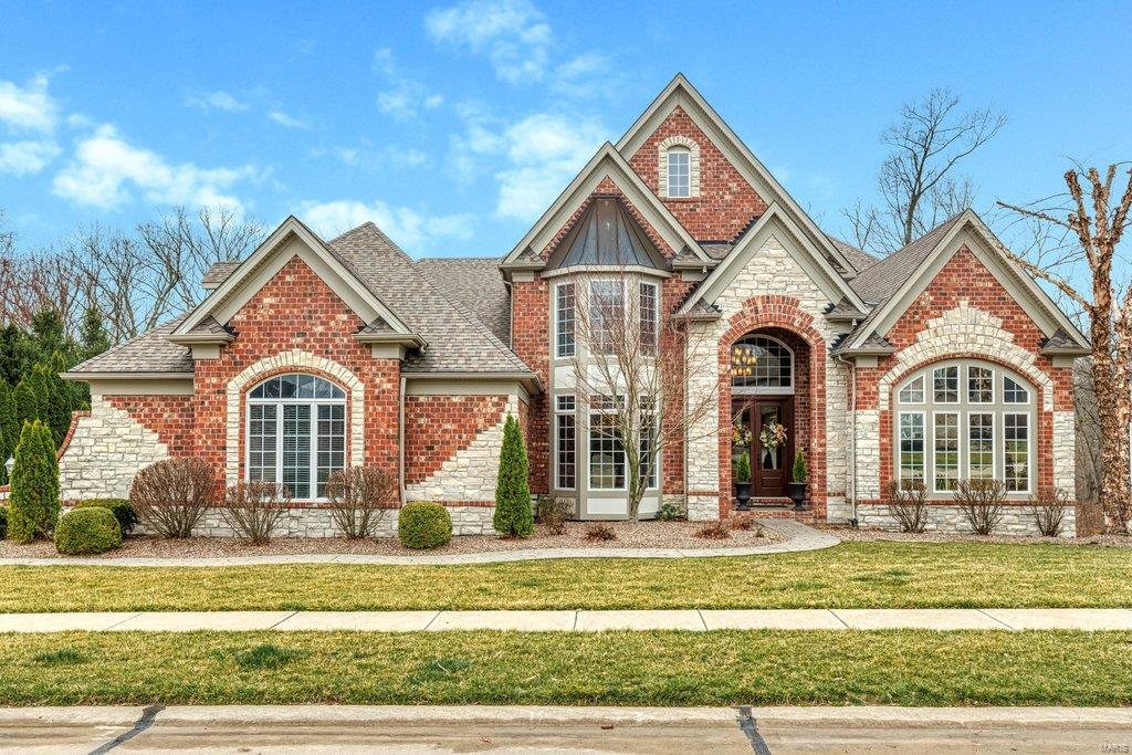 Spectacular brick & stone 1.5-sty Estate home. Impressive 2-sty foyer leads to handsome study surrounded by library paneling & bookcases, elegant dining room framed by arched entryways and stunning great room with architectural columns & marble fireplace flanked by 2-sty windows. Spacious open kitchen with 42” cherry cabinetry, premium appliances & planning center adjoins light-filled breakfast room with bay window & atrium door to patio & vaulted hearth room with wood beam trusses & floor-to-ceiling stone fireplace. Coffered master bedroom suite combines the enjoyment of a direct vent fireplace with sitting room & beautifully appointed bath. Front & rear staircases access 4 additional bedrooms & 2 full baths. Walk-out Lower Level includes recreation room, game room with wet bar & dining area plus office, 6th & 7th bedrooms & full bath. Situated on a 1+ acre lot with patio with fire pit, resort style pool & pool house, landscaped gardens, 3-car garage & an additional 25’ x 12’ garage.