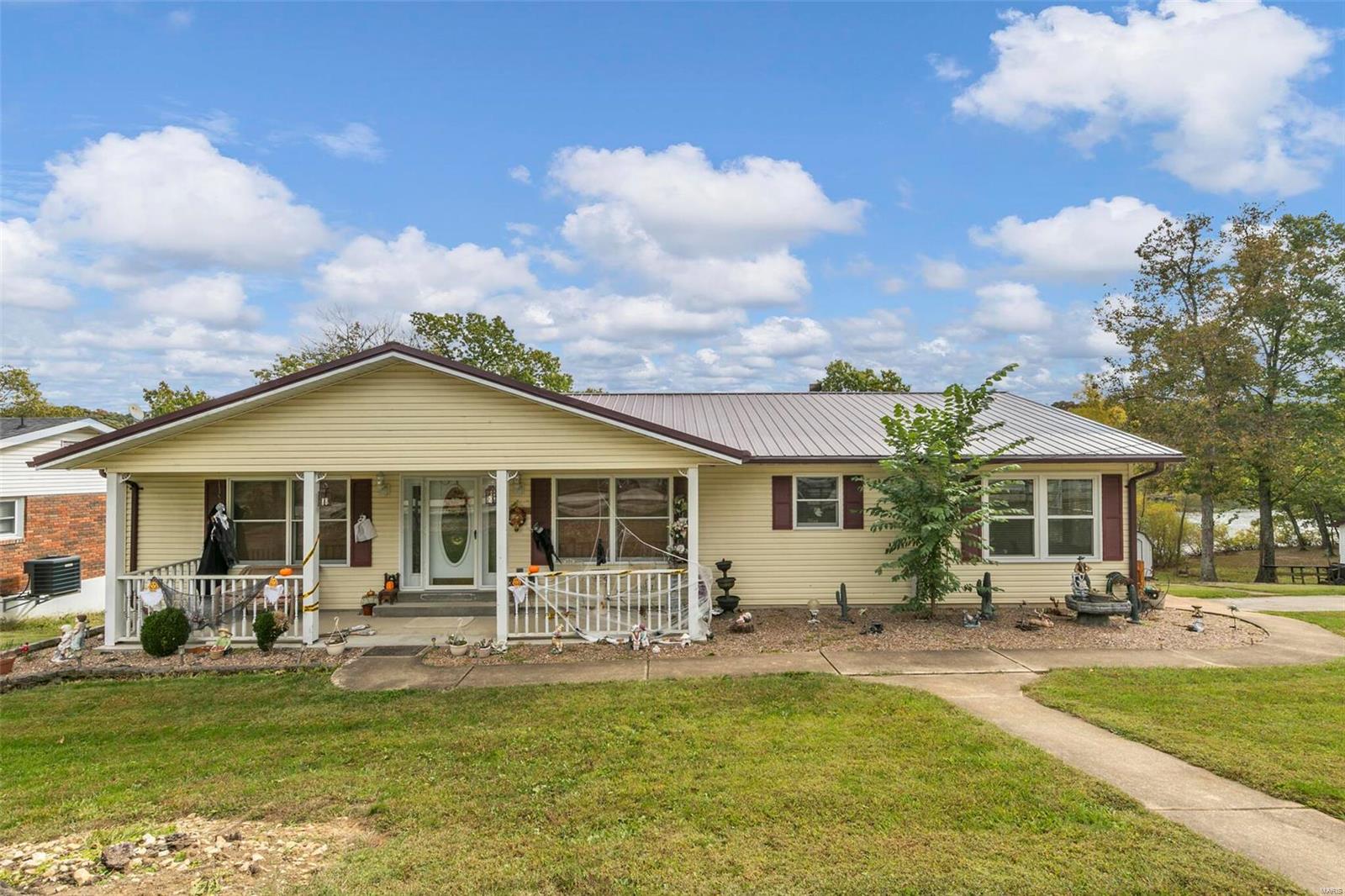 LAKE FRONT PROPERTY-- This Ranch Style home offers 4 bed, 3 bath and almost 2500sf of finished living area.  This beautiful home is located on almost a full acre fronting a 13 acre lake.  Oversized kitchen with center island, separate breakfast nook, formal dining room, living room, and Huge Master Suite with walk-in closet.  Main Floor Laundry, Woodburning Fireplace, Large Closets.  The partially finished basement is a walkout with recreation room, full bathroom, bedroom with egress window, and a storage area.  Huge Deck off the rear of the home overlooking a level backyard and the beautiful lake.  Large Dock area, storage sheds, and garages for 3-cars.  Newly installed metal roof, newer thermal windows, and much more updates.  Come and live in this amazing home and enjoy the serenity of lake life living.
