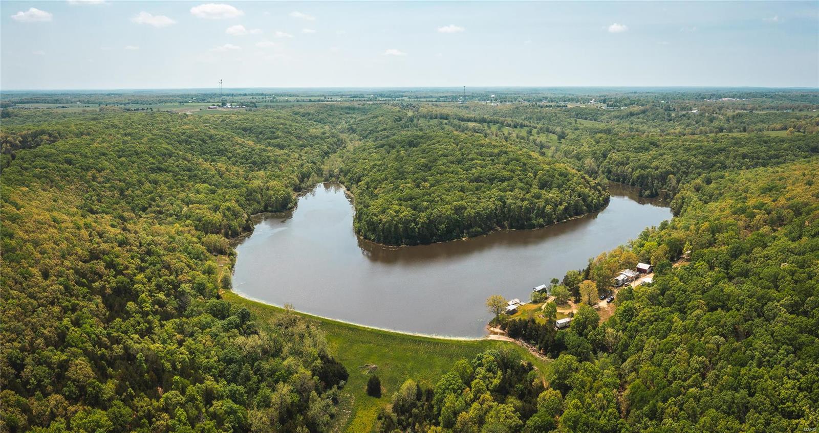 Looking for the perfect recreational property, own your own piece of paradise on this 230 acre farm with an incredible 25 acre lake that is well stocked with trophy bass, bluegill, and catfish. House site placed strategically to enjoy the view of the lake with easy access to boat docks and fishing. This land is a sportsman’s dream offering great turkey, deer, and small game hunting. The lake attracts many waterfowl species each year and would be a perfect place for the duck/goose hunters as well. Get the remote back country feel but located just a few short minutes from Belle, MO with all the necessary small-town amenities. Accommodations currently are a trailer with built on rooms including 3 bedrooms and 1 bath. Also has vault style concrete room for storage. Great future building home site and could easily be divided to offer family member lakes access. Don’t miss out and call today.