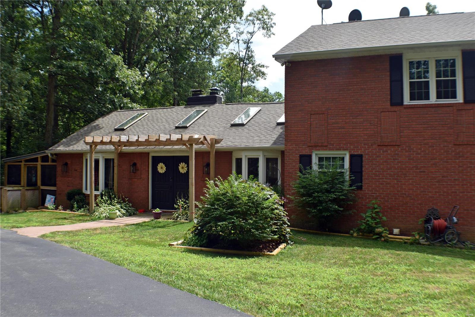 Attached garage is heated and cooled. 2 car carport plus storage.  Replacement windows plus updates.  Hot tub is negotiable.  Fireplace in basement is double sided.  Fireplace in living room has insert.  Screened porch.  Main level laundry.  Lots of parking space.  Generator will cover most of the house.  Gas back up fro HVAC system.