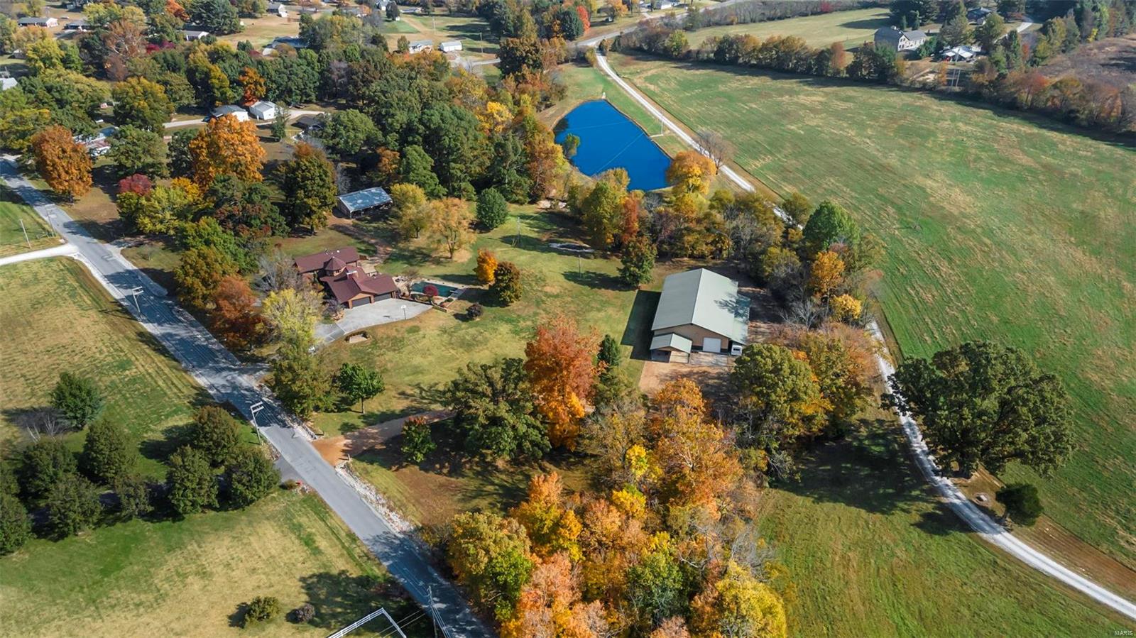 Retreat from the busy city to your own personal getaway, complete with live running creek, in ground swimming pool, hot tub, stocked fishing pond, 60 x 100 heated shop, 4 stall horse barn, and a quality custom built home situated on 9.55 unrestricted acres.
From the solid wood doors, to the custom cabinetry throughout - this trophy property is a stately and solid built fortress ready to house a new family!  Elevate your style of homesteading with the beautiful grounds where you could move in your family, build a cabin, or just continue to enjoy the peace and serenity that surrounds you.  If you are looking for the perfect place to enjoy charm and sophistication, look no further than 4038 County Road 435.  From the soaring vaulted ceilings to the postcard picture perfect views, the uncompromising quality will capture you when you enter the front door into the two story foyer! Qualified buyer, schedule your appointment today!