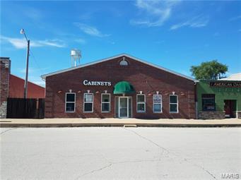 Commercial Property – This 3360-square foot one level building is divided into 3 different spaces.  Currently has rented our 1424 square feet – There is 1056 square feet all open area that fronts the street and 880 square feet space with 3 offices that has an alley entrance – would make a good investment property for all rentals or you could occupy part of it until your business is ready for future expansion - Location: City, Downtown, Rural