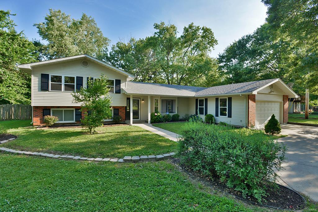 Welcome to this Ballwin Gem nested on almost an acre of level land! The location of this Tri-Level home is like none other and to have almost an acre lot in the one of the best zip codes in the country is simply a treasure! The inside boasts soaring vaulted ceilings in the open floor plan along with cherry wood kitchen cabinets, tile counter top and stainless steel appliances! The home features laminate flooring throughout and leads to a raised Master Bedroom Suite! The suite features vaulted ceilings, a beautiful walk-in closet with a shelving system, and a gorgeous on suite bath with high ceilings, his/her double sinks and separate tub! The diverse and open basement family room can be utilized for multiple functions whether it's a play room, game room, or a relaxation area. The very large, flat, and fenced backyard will surely fulfill just about any home outdoor activity or sport that comes to mind! Be the go to house for fun and entertainment and live the dream!!