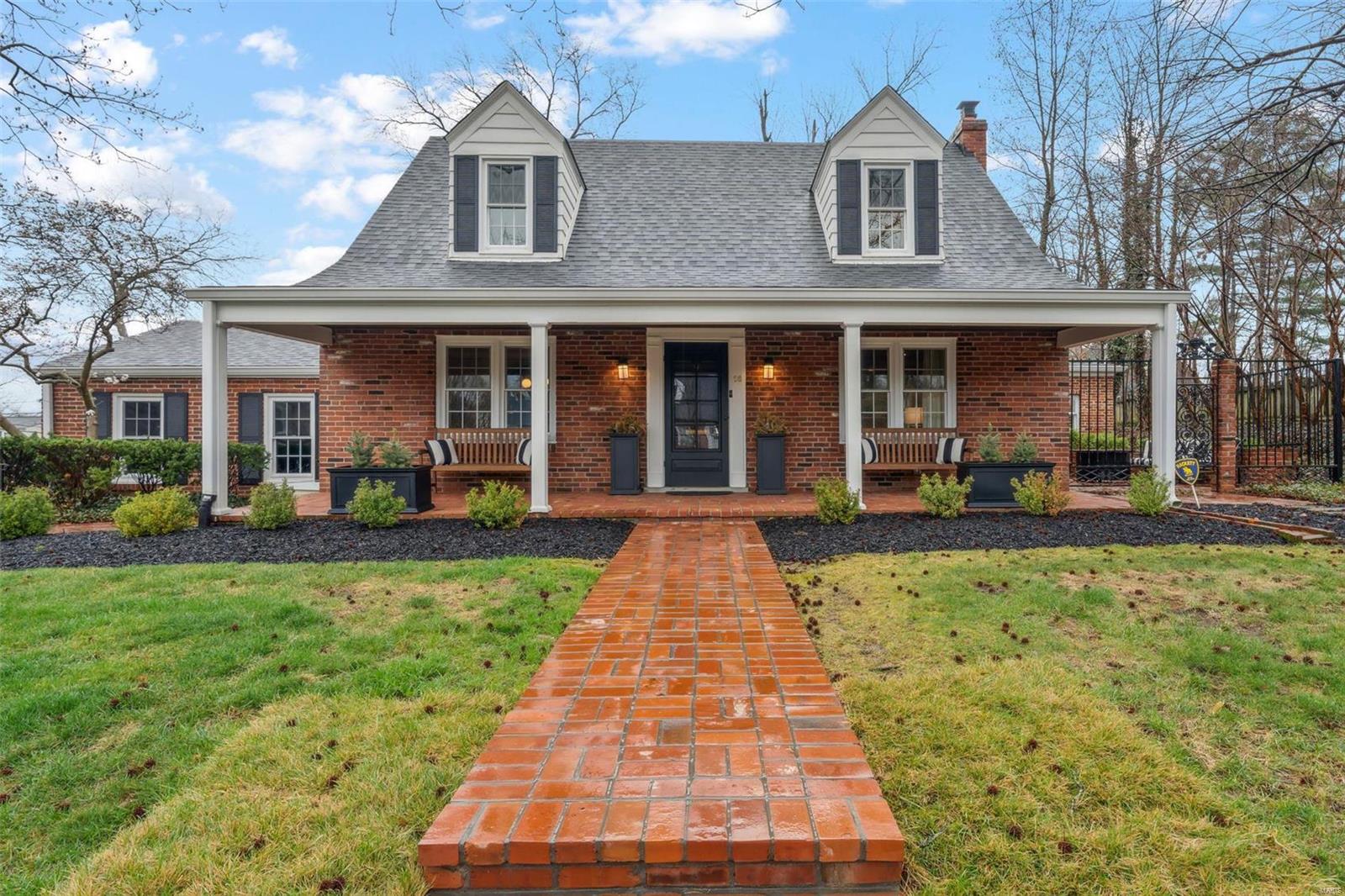 Step into a world of refined beauty and contemporary luxury in this meticulously renovated 1953 home that seamlessly blends historic charm with modern amenities.  Nestled in a sought-after neighborhood, this 5-bedroom residence exudes character and sophistication at every corner.  As you enter, note the original hardwood floors complemented by the freshly painted walls and moldings that adorn the living spaces.  The gourmet kitchen features high-end stainless steel appliances, mother-of-pearl backsplash, quartz countertops and custom cabinetry.  The living room boasts a statement fireplace and french doors leading to a secluded courtyard with wrought iron gates and timeless brickwork. The master suite is complete with a spa-like ensuite bathroom featuring heated floors, soaking tub, walk-in shower and custom closet (2nd master suite is located upstairs). This home offers quality updates throughout including plumbing, electrical and HVAC ensuring a worry-free living experience.