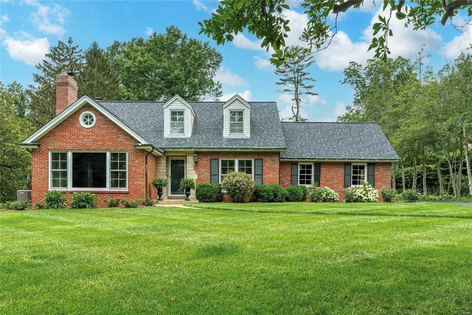 Picture perfect Cape Cod extensively updated throughout while maintaining the charm & character of the original architecture. Center hall floor plan features well-proportioned rooms with detailed trim work, cove ceilings & refinished oak hardwoods that extend throughout the main living area. Gracious hardwood foyer leads to formal living room, spacious family room with brick fireplace, knotty pine-paneled dining room with fireplace and private study with wide bay window that overlooks brick courtyard. Culinary enthusiasts will love the designer-inspired kitchen with beamed cathedral ceiling, 42" glazed white cabinetry, quartz countertops, KitchenAid appliances, 10' center island & entertainment center with granite fireplace. Main floor primary bedroom suite with luxury bath offers an appealing retreat. Hardwood floors continue to the 2nd level with 3 additional bedrooms plus bonus room & hall full bath. Lower Level includes paneled recreation room with wet bar & abundant storage space. Additional Rooms: Mud Room