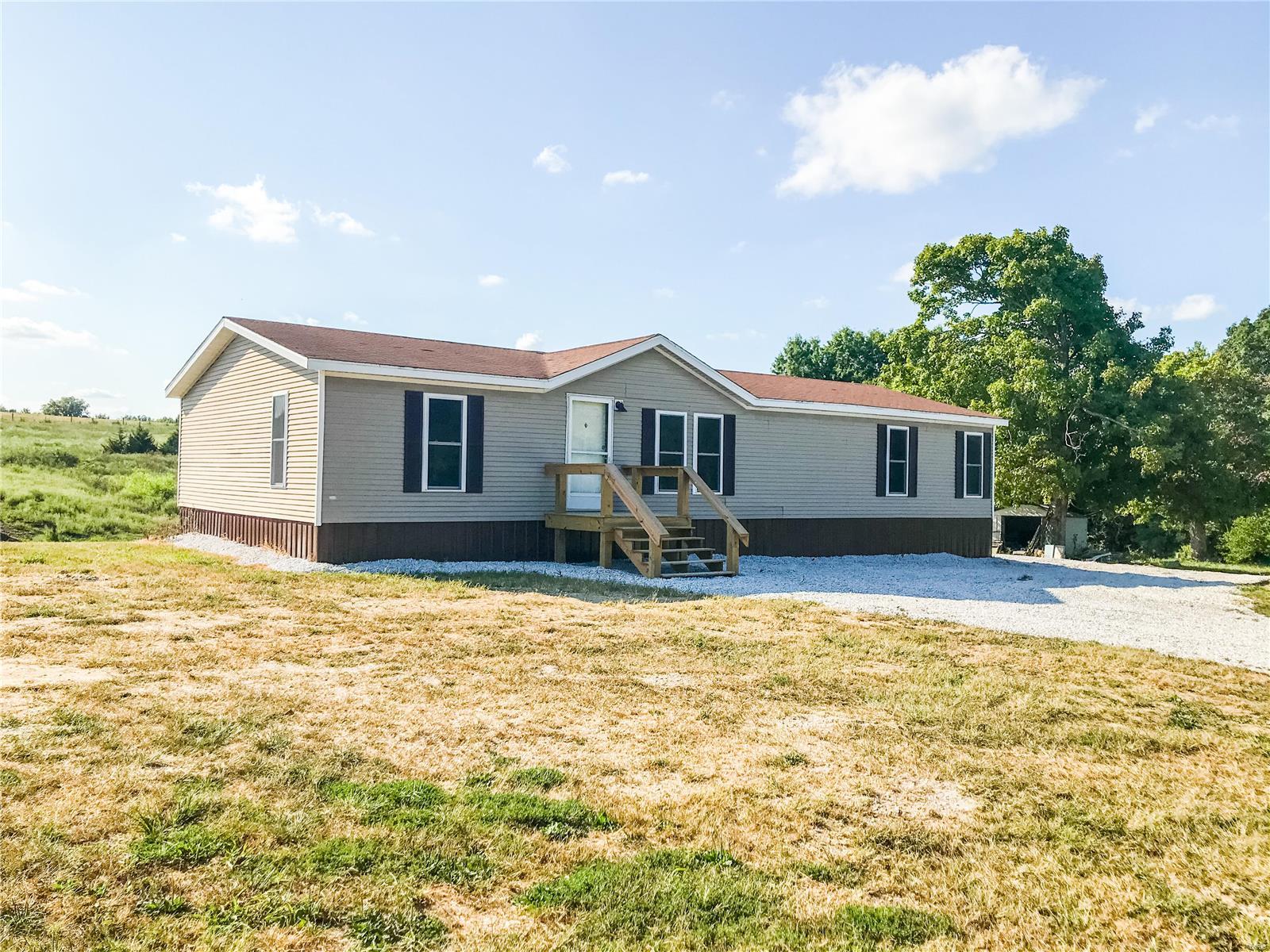 Looking for a great home in the country? This 3 bedroom, 2 bath double wide sits on 5.7 acres just minutes from Paris, close to Mark Twain Lake and on a dead end gravel road.  This home features a newly installed ac system, decks and flooring as well as an updated kitchen with stainless steel appliances.  You can enjoy the 5.7 acres with beautiful mature trees and access to a beautiful lake that is stocked and ready for you to enjoy! You don't want to miss this one! Additional Rooms: Mud Room