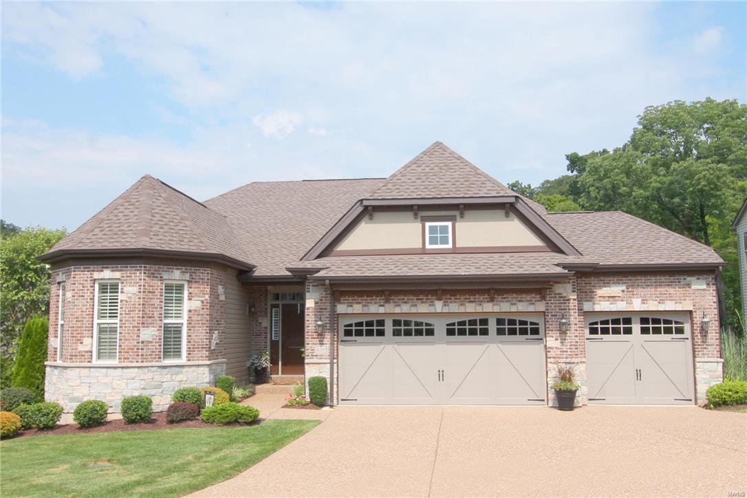 Simply gorgeous home.Elegant details & upgrades throughout.Shows like a display.Quiet beautiful subdivision offers a gated entrance, heavy trees/woods ~ private setting. 3 car generous sized garage. This home offers a desirable divided floor plan bedrooms 2 & 3 on one side of the home & the luxurious master suite on the opposite side. Stylish wood flooring. Formal dining rm. Soaring ceiling in the great rm (12ft tall) flanked by transom windows, custom shutters & exquisite window treatments, private coffee deck plus secondary composite covered deck with ceiling fan(could be a screened porch).The kitchen is a cooks delight with granite counter tops, stylish backsplash and upscale stainless appliances. Not to mention a wonderful finished walk out lower level -tall ceilings (10ft), rec rm,potential bedrm or home office,full windows, rough in for wet bar,full bath & more.  Irrigation system,pet fence.*Seller is willing to sell the décor & furniture pieces to make this home an easy move.