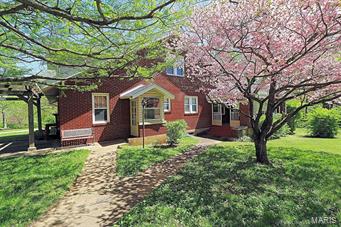 Unique find in the city limits, 1 1/2 brick/vinyl home sitting on 7 acres more or less with 56 x 36 shop with electric and concrete floor.
This lovely 5 bedroom, 3 bath home is filled with charm and character. Main level includes a spacious living room and fireplace with
gas insert, updated kitchen with new counter tops, stainless appliances & separate dining room. The main level master bedroom with adjoining bath is also a plus, along with den/office for multiple purposes. The upper level has lots of space for a growing family with 3 additional bedroom, one with an adjoining 12 x 11 room would make a great play room. This is a must see to appreciate property with several outbuildings, large yard, circle drive, and numerous other updates making this a perfect forever home! Call for a showing today.