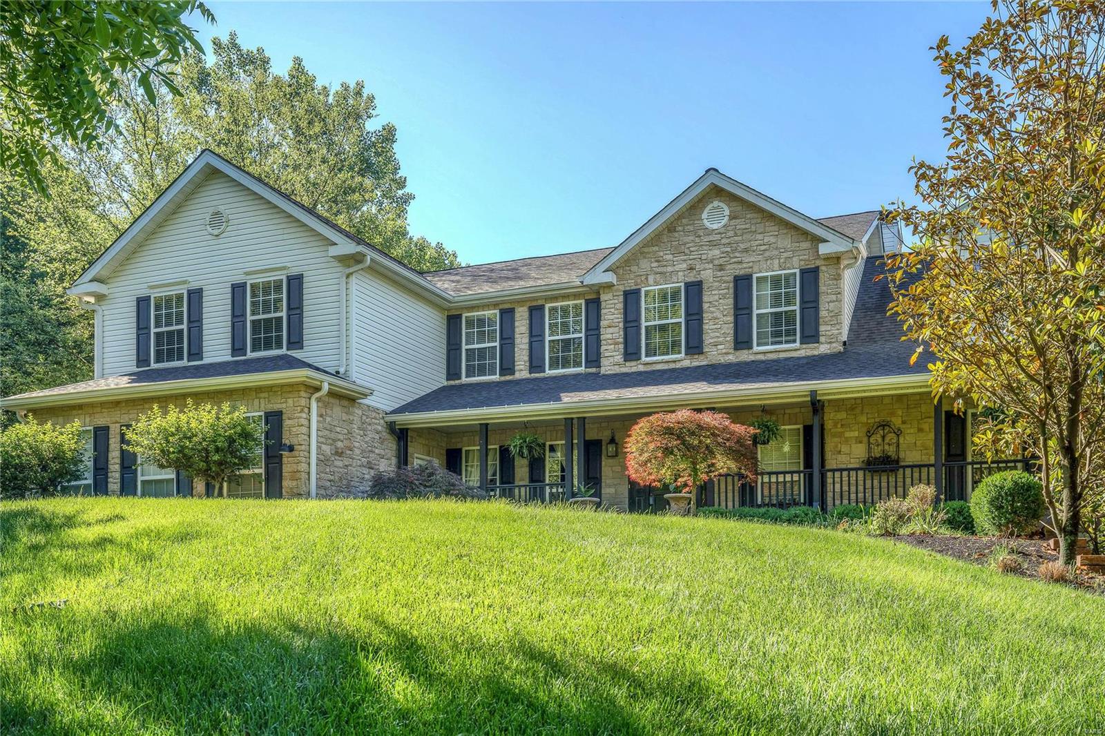 Beautiful private home built for entertaining friends and family! This home has just under 8000 sq ft of living space on a 3 acre lot that is nestled on a private drive in the heart of Rockwood Schools. The kitchen is a chef’s delight with top of the line appliances, custom cabinetry, massive center island, granite counter tops and Wolf appliances. Luxurious master suite on main level with private balcony and fireplace. Enjoy the extremely private backyard under the covered patio with outdoor kitchen and overlook the pool. The walk out finished basement allows for all year round entertaining with a large bar, fireplace, game room and bedroom. Relax in the hot tub next to the outdoor fireplace. 3 car attached garage plus a carriage and pool house. Enjoy 2 laundry rooms, 5 fireplaces, beautifully kept hardwoods throughout, custom closets, the details are well thought out to create wonderful family memories. This home is accessible for everyone with ADA doors,built in ramps and elevator! Some Accessible Features